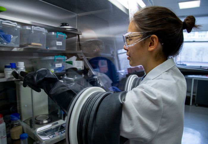 Female researcher in a lab wearing a lab coat