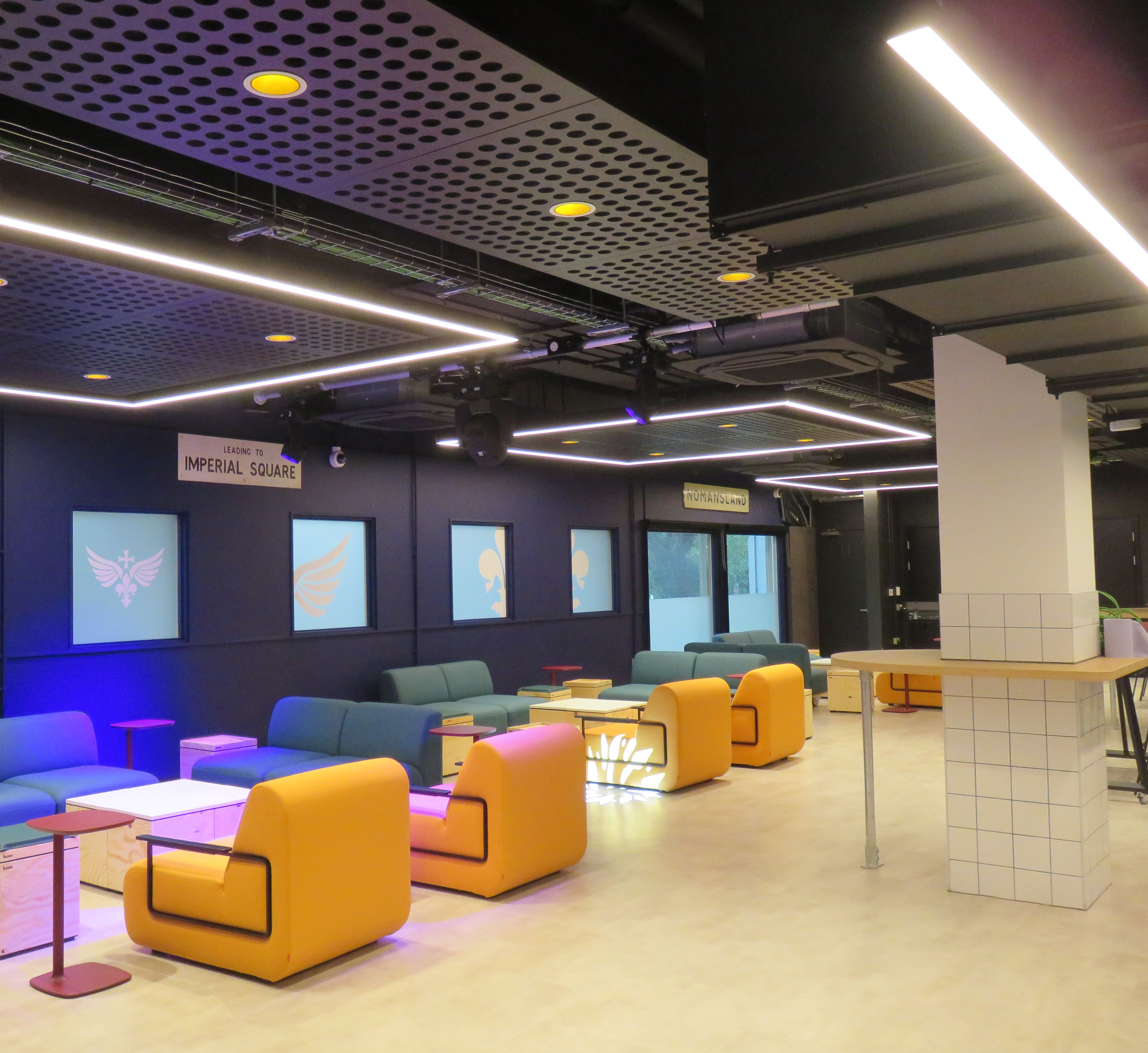 The colourful relaxed seating, clar floor and colourful lighting in the 'party' area of the bar