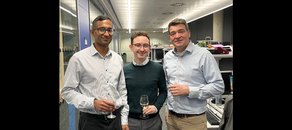 Shane and his examiners toasting to a successful viva!