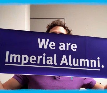 Imperial alumnus holding up a banner that says We are Imperial Alumni