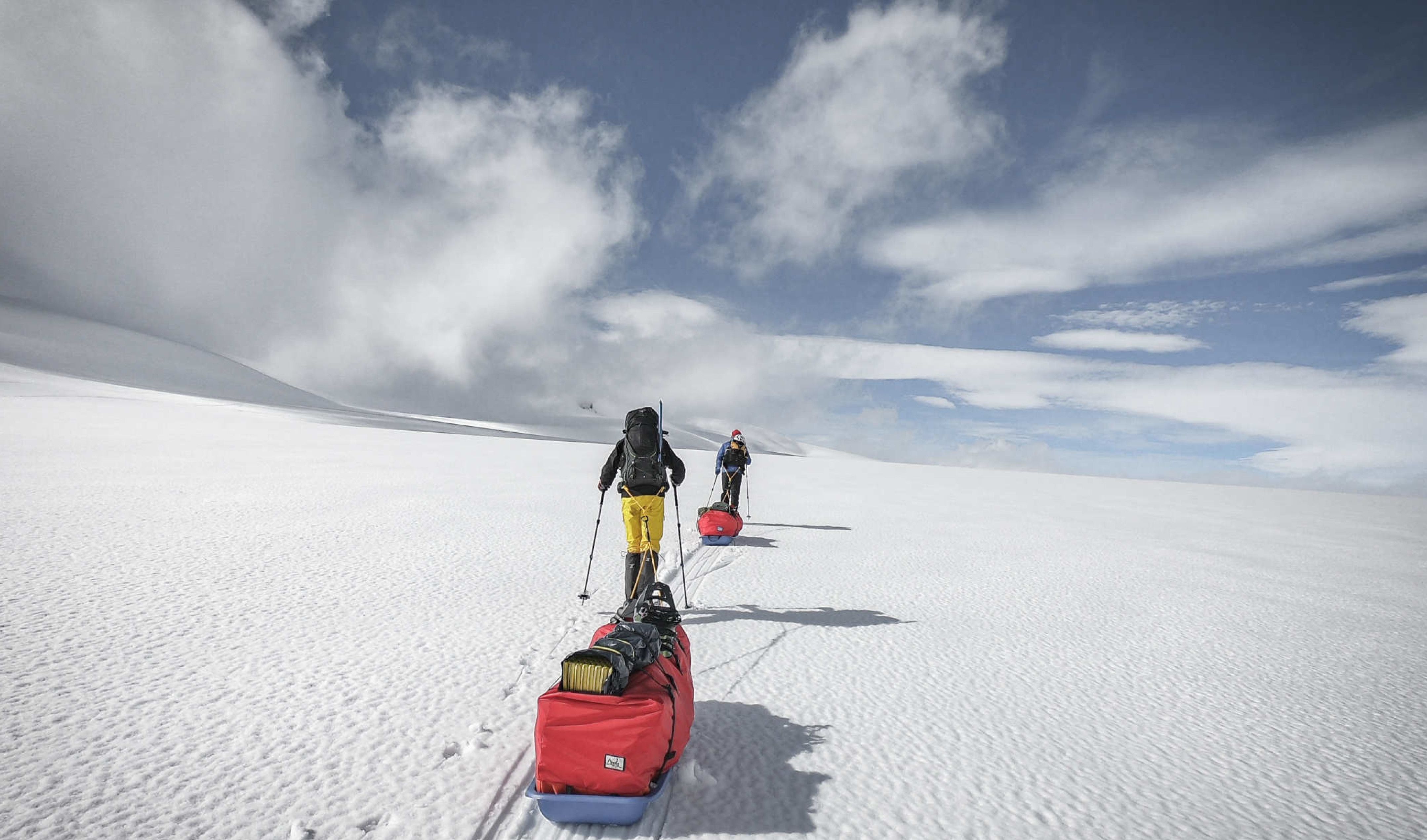 Two students hauling a sledge in Norway
