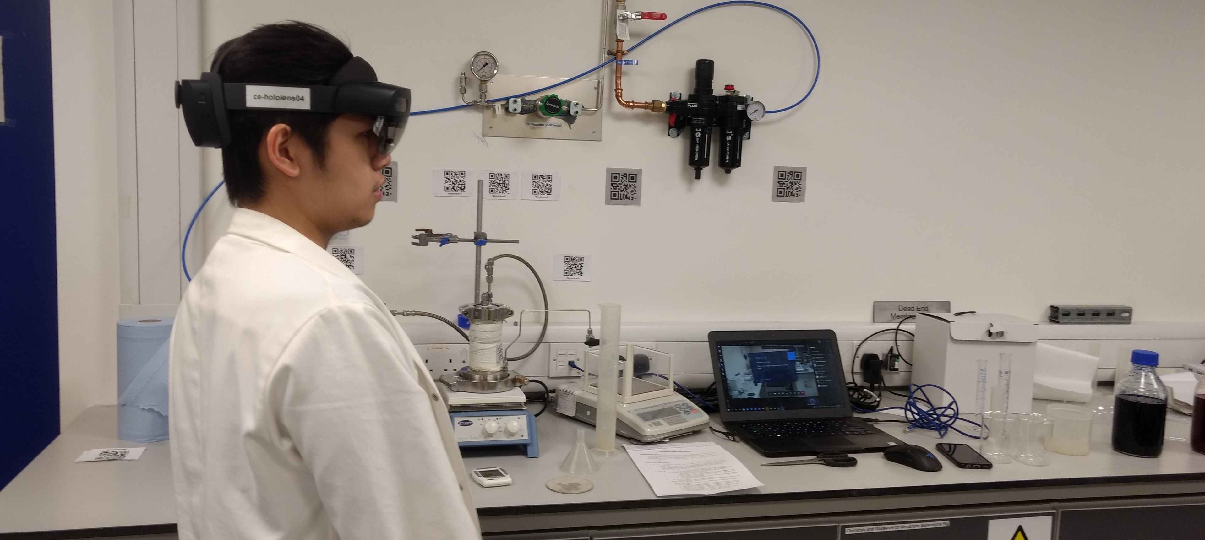 Male students wearing a Hololens headset in a lab