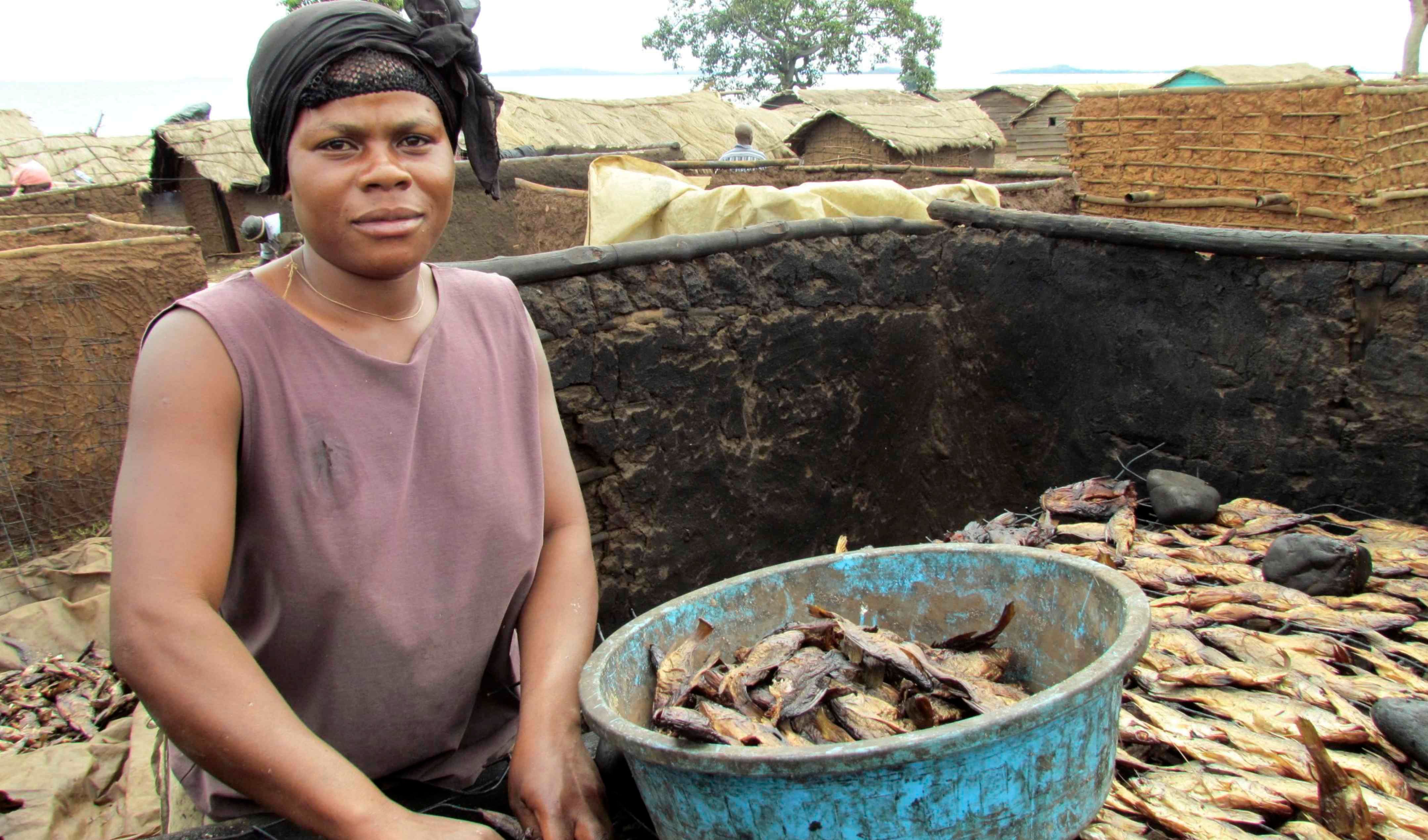 Entebbe lady dry curing the fish for food longevity