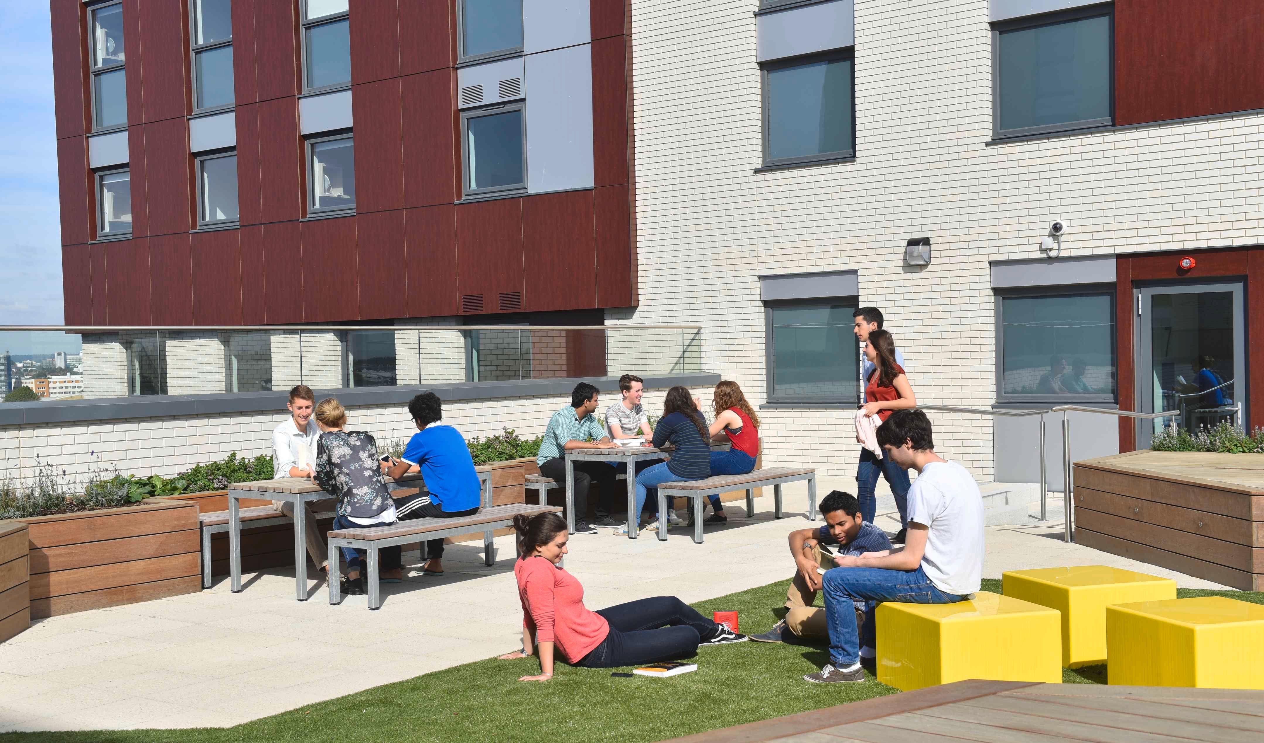 A group of students relaxing on the roof of Imperial accommodation.