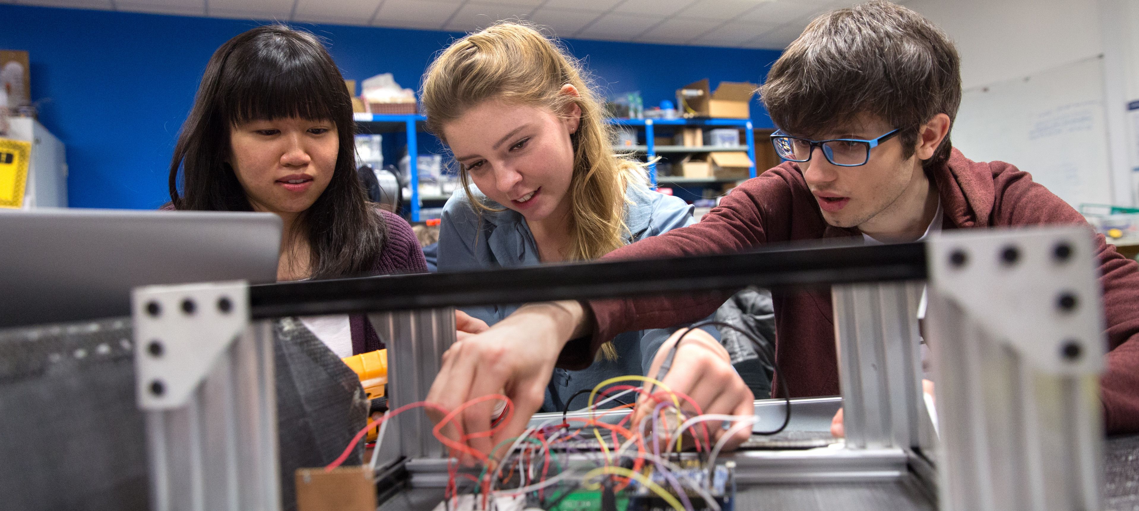 Three Electrical and Electronic students working in the robotics lab