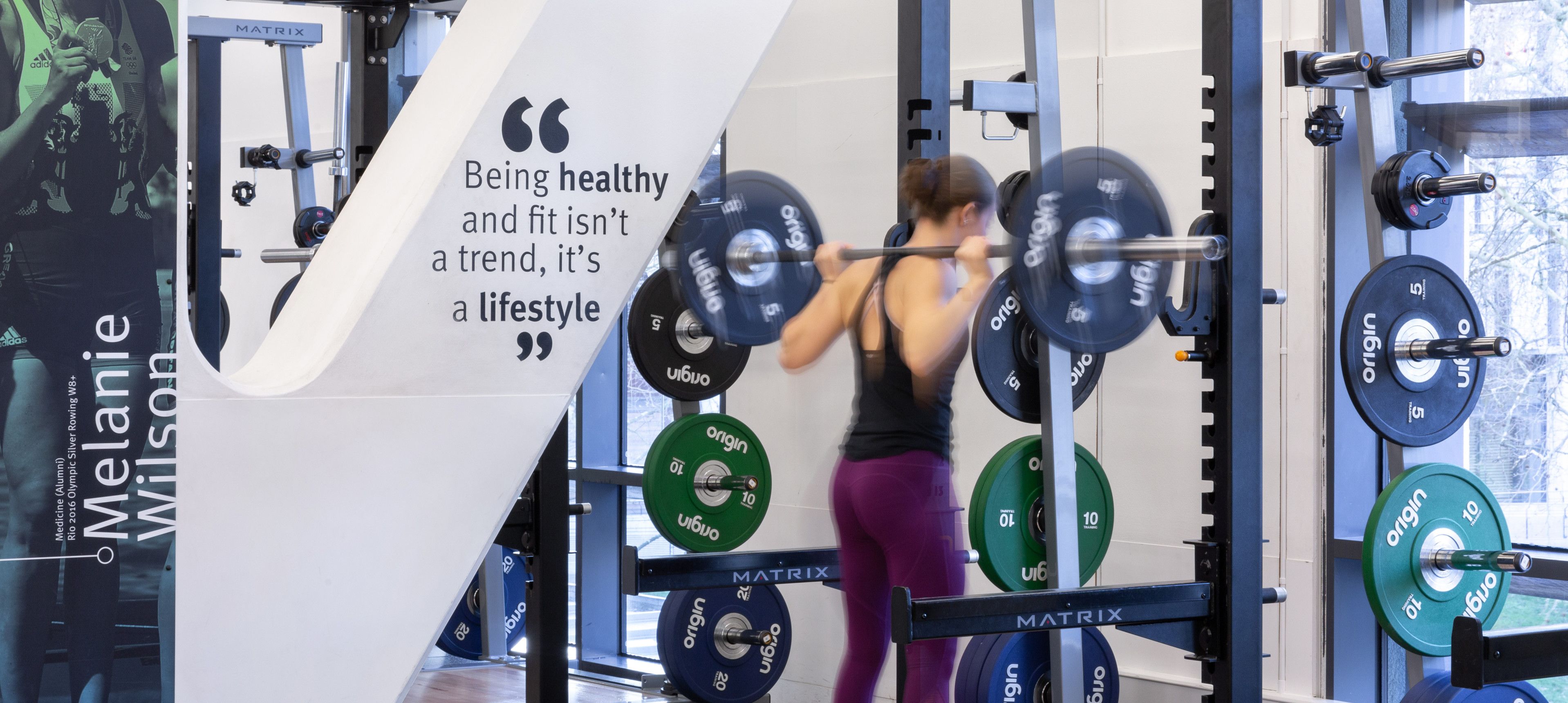 An Imperial student lifting weights in Ethos sports centre on our South Kensington Campus