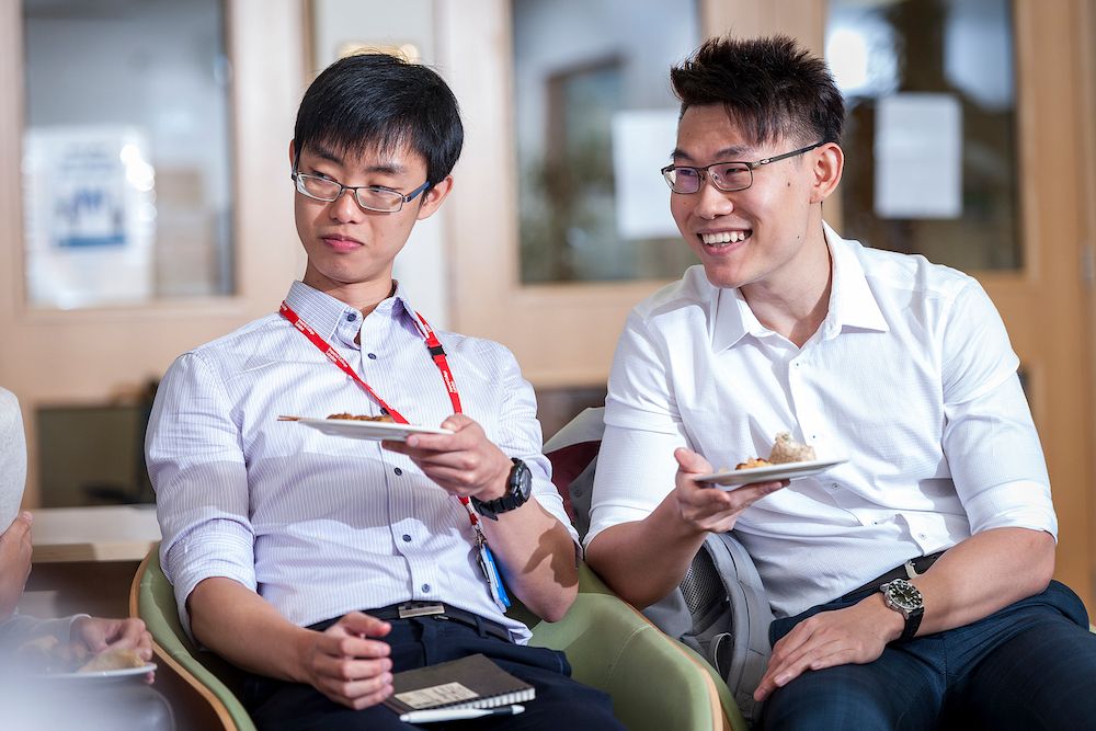 Two students laughing and talking