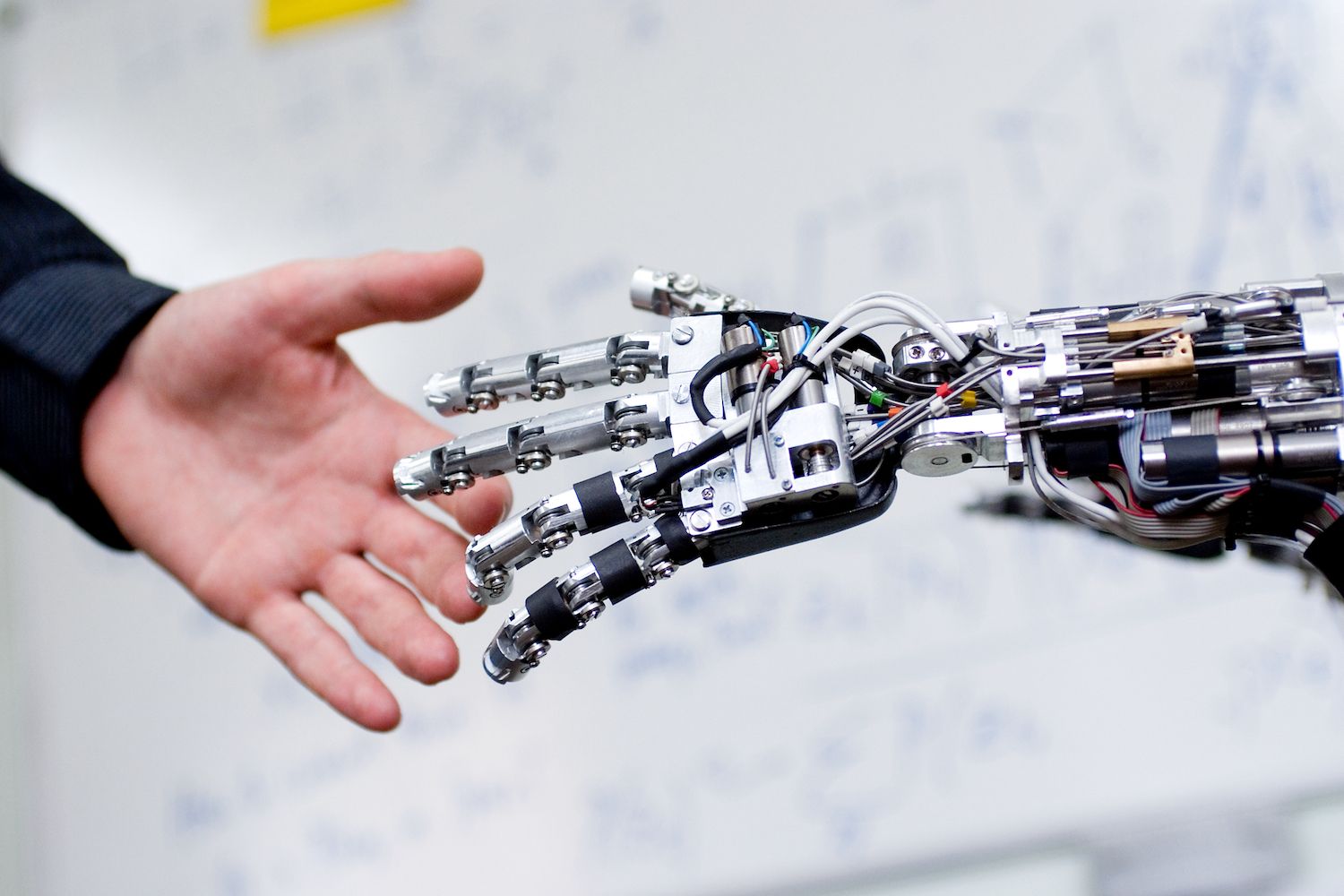 Experimental robotic hand shaking hands with staff