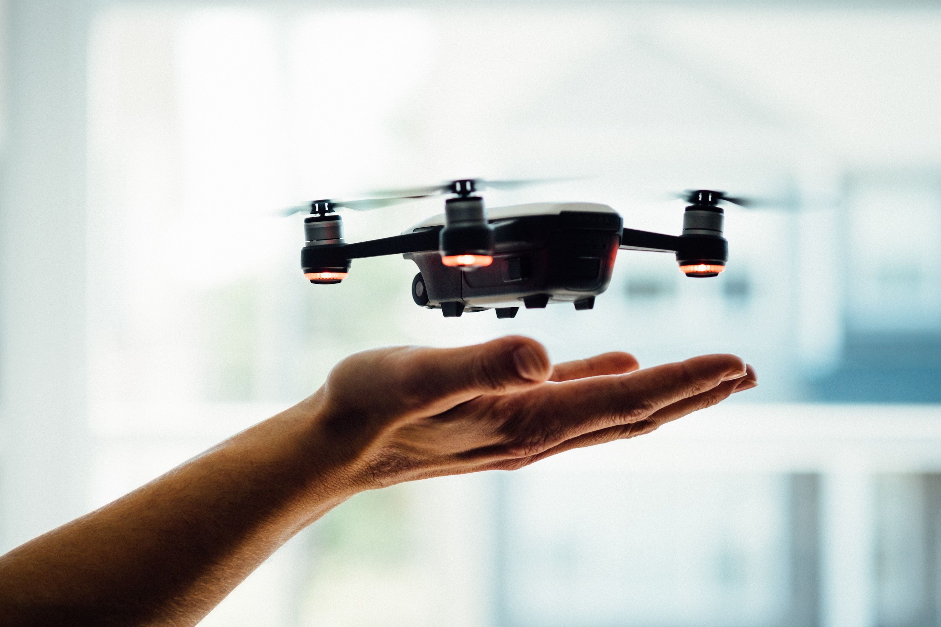 Hand releasing flying drone.