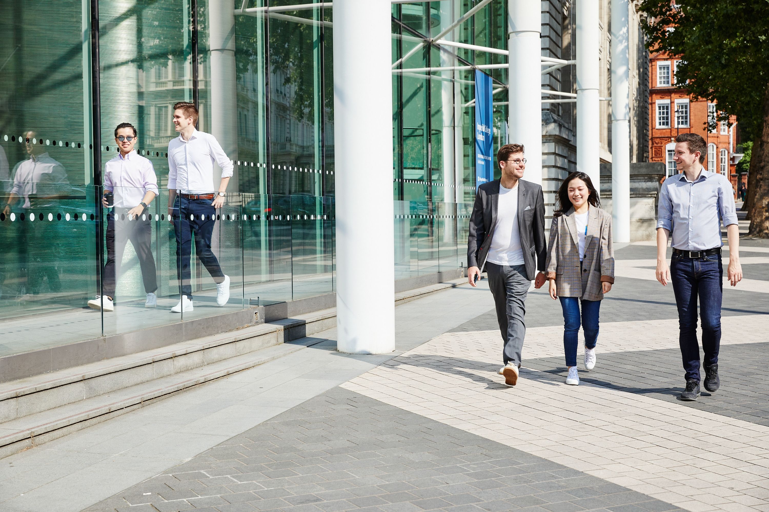 Three students walking on campus