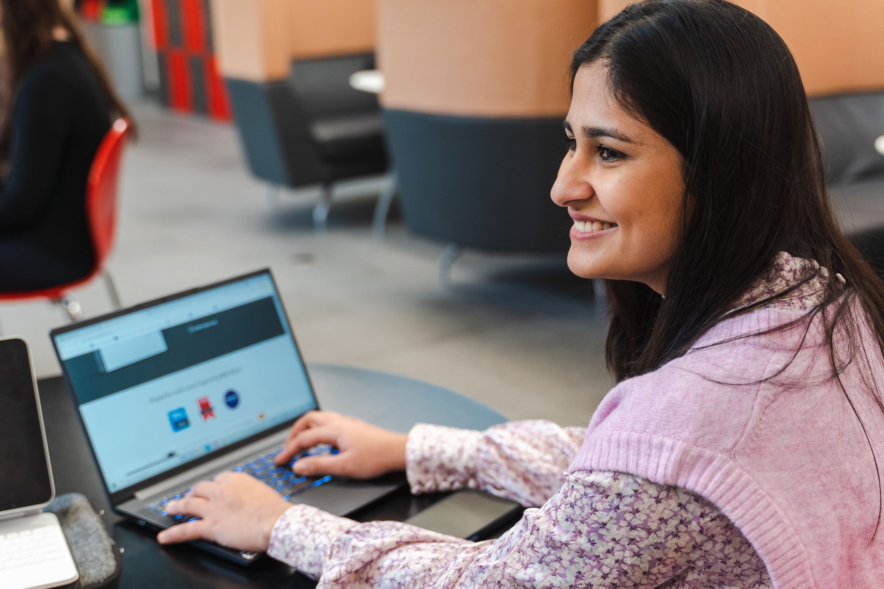 Student sat working at a laptop