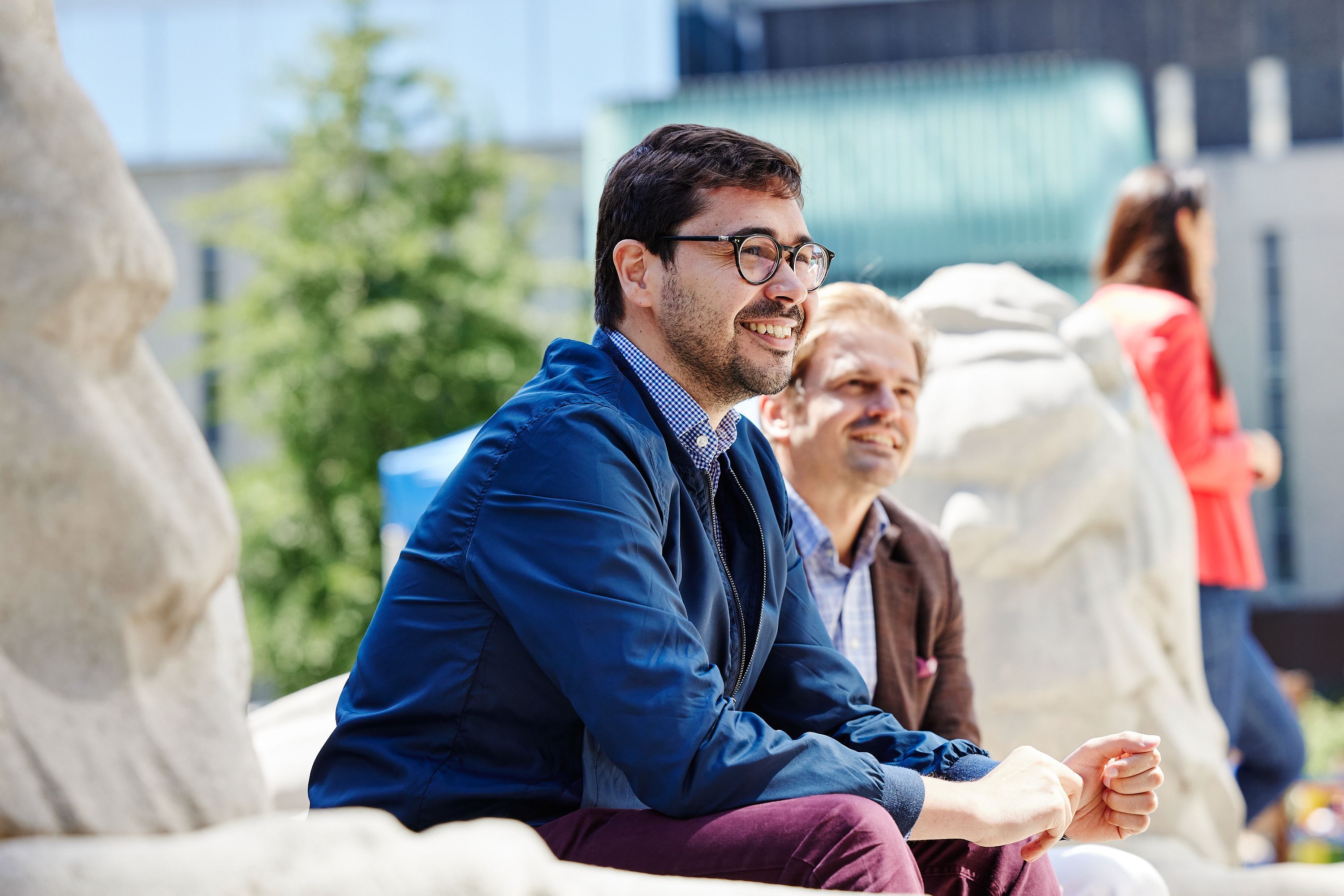 Two male students sat by the Queen's Tower