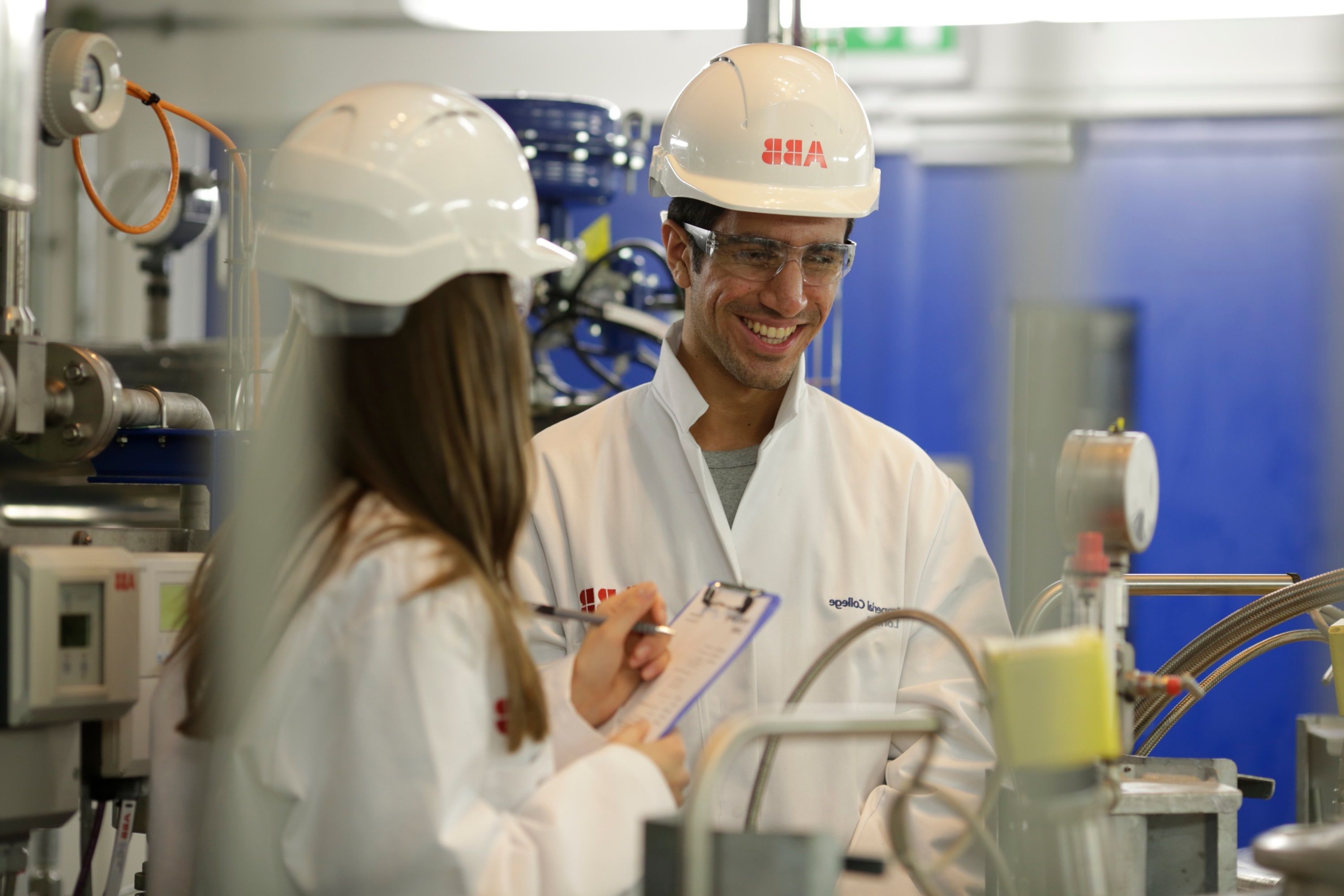 Two students in a lab wearing helmets