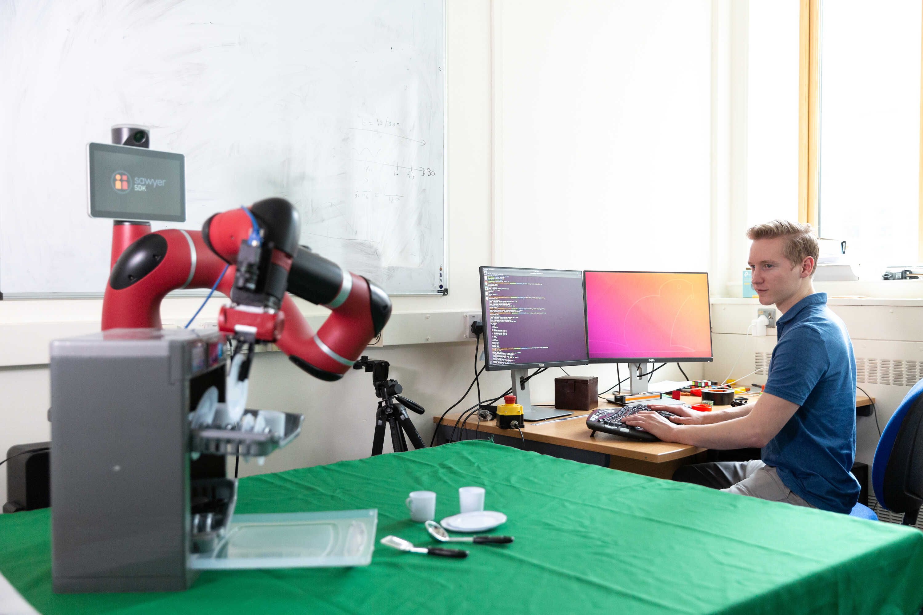 PhD student working with robot