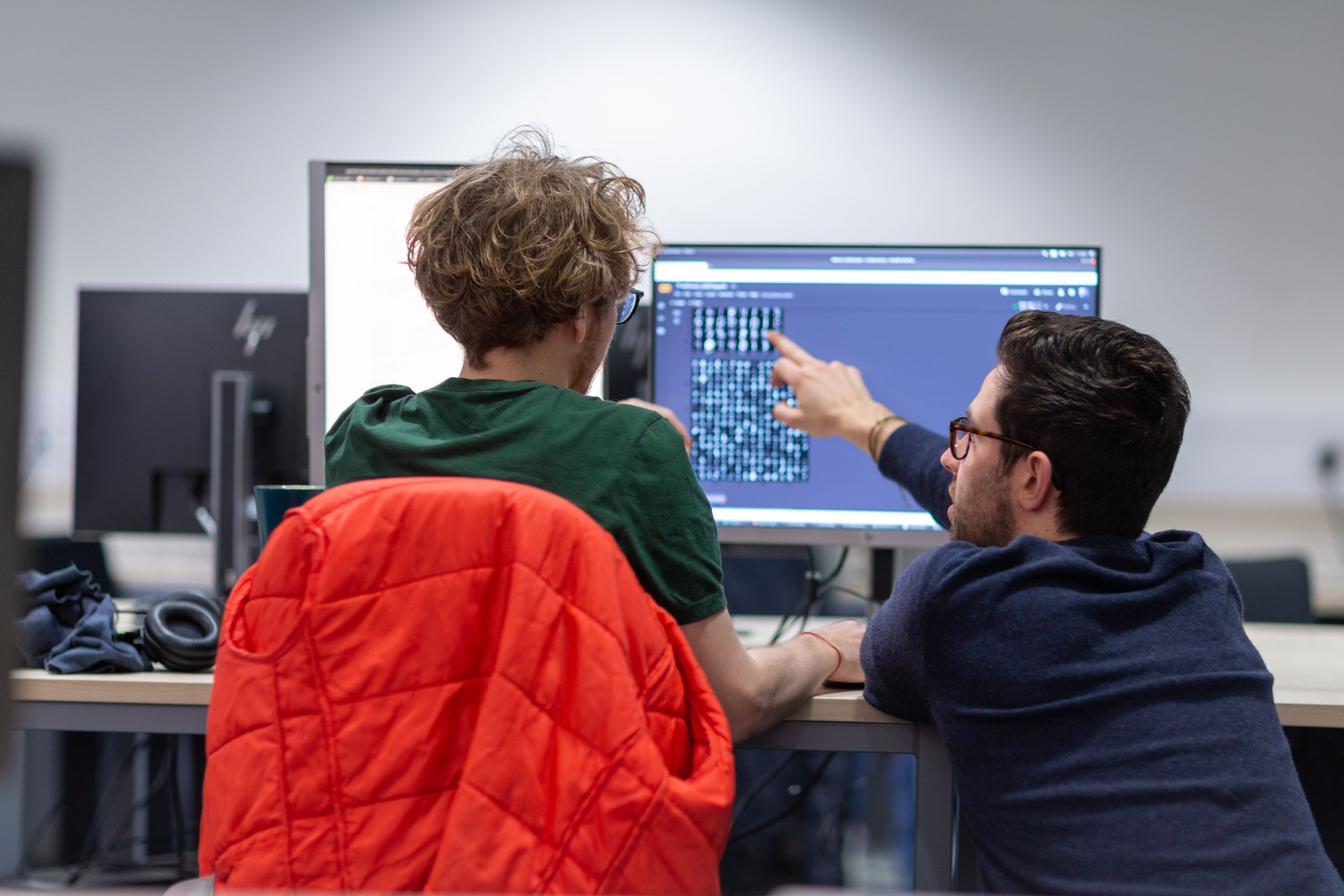 A student and a a lecturer looking at a computer