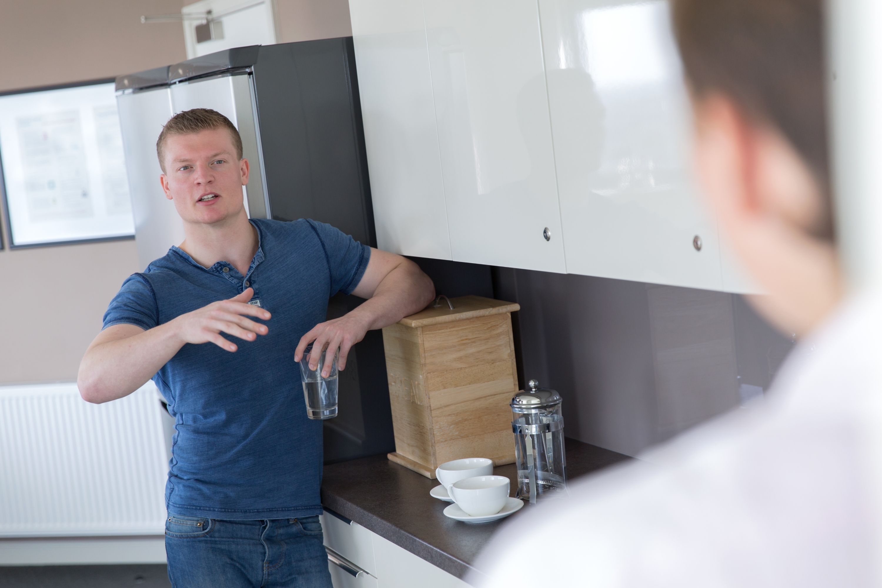 A student chatting in a kitchen