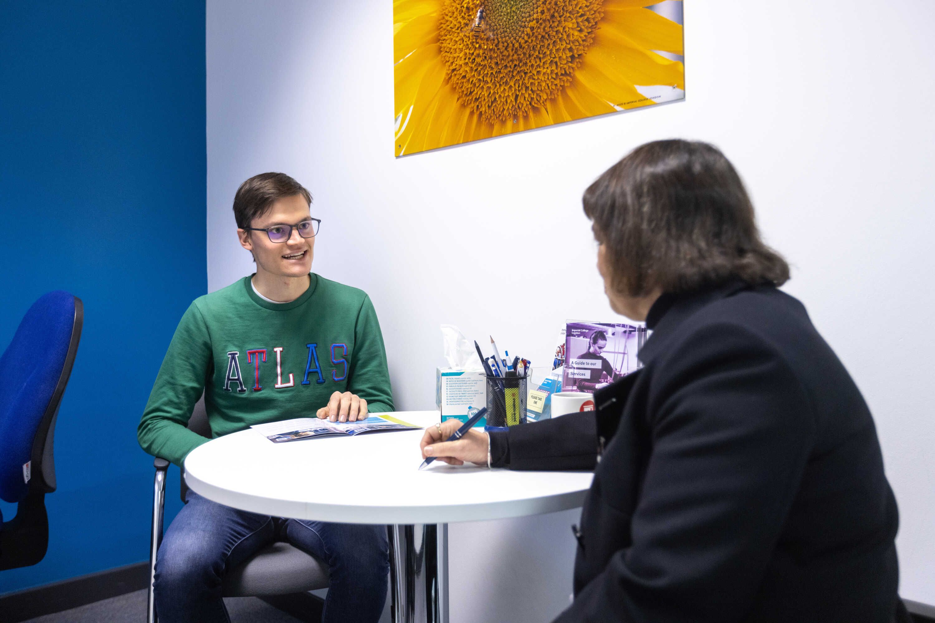 A student talking to a staff member