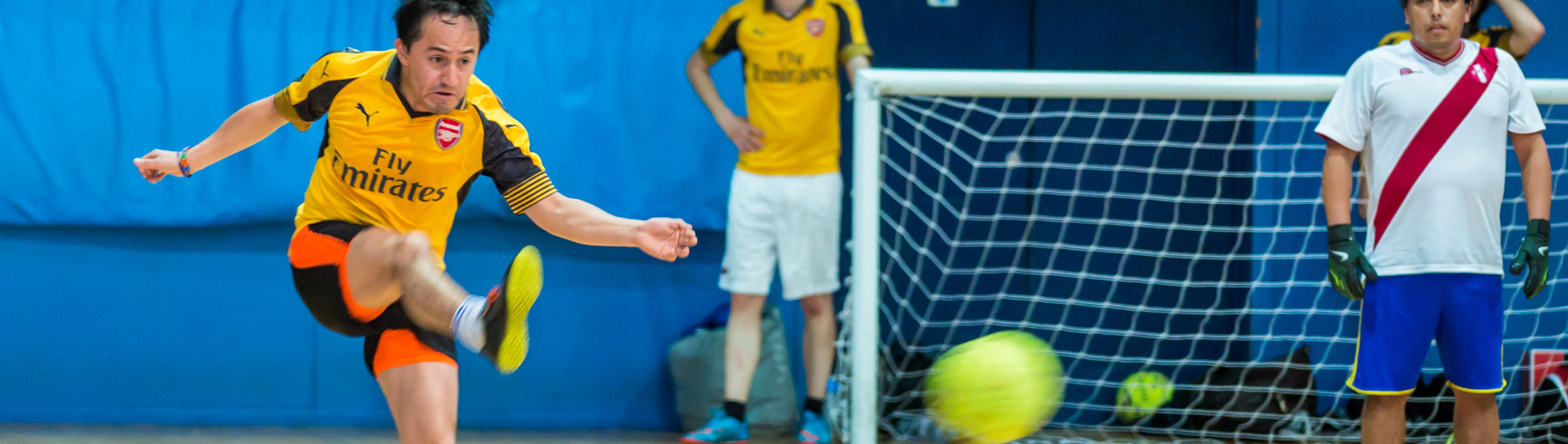 Staff playing five-a-side-football in Ethos Sports Hall