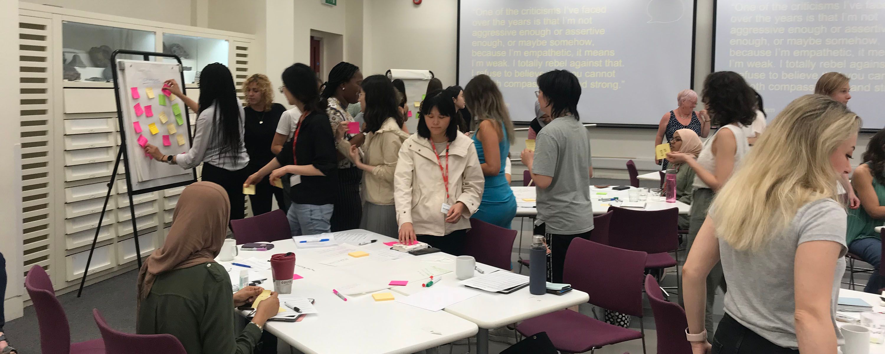 Groups of women working on activities at tables