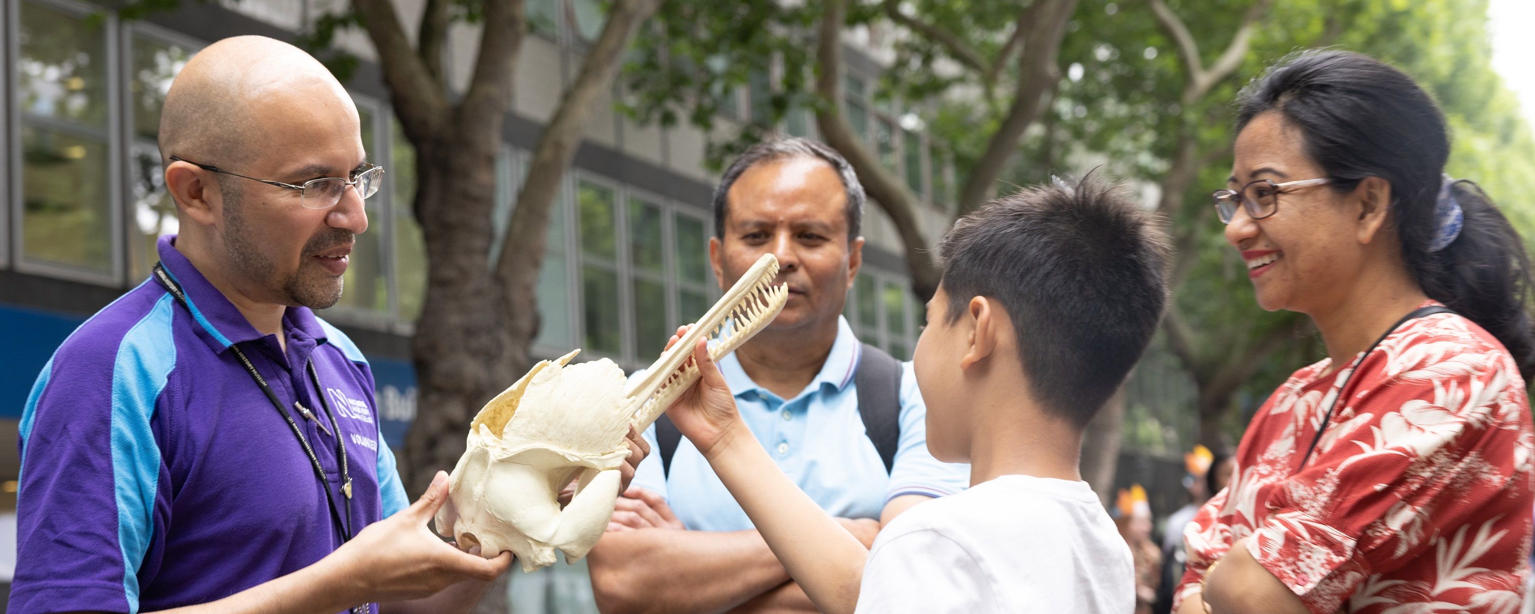 Researcher and visitors with dinosaur public engagement activity