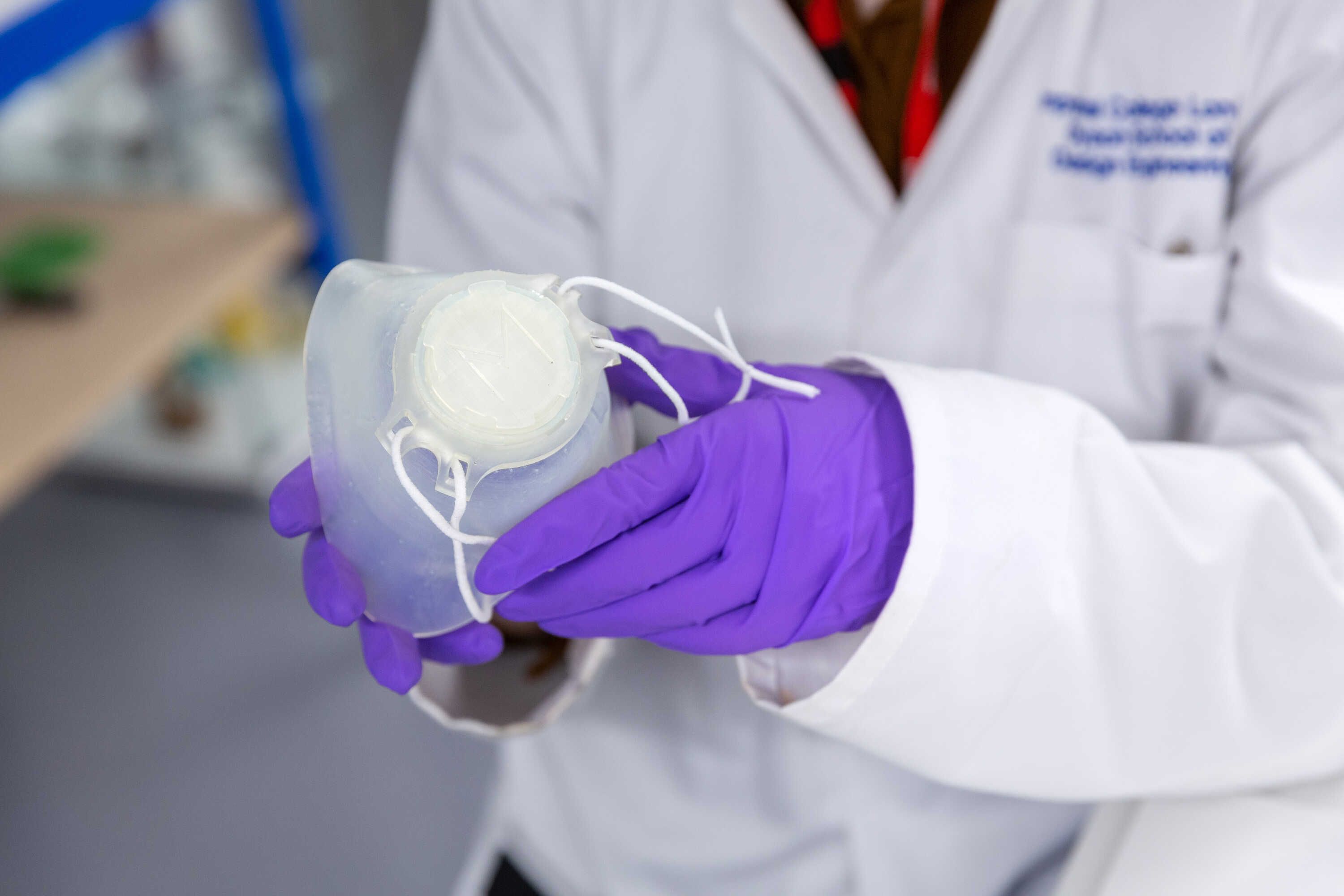 Connor Myant holds a prototype of a new, personalised face mask for protection against COVID-19