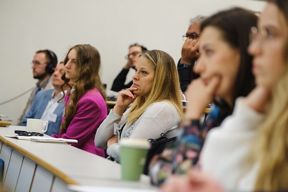 Audience in lecture theatre listening