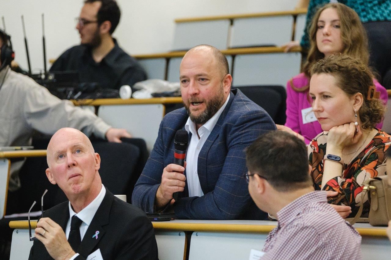 man  in audience asks question with microphone