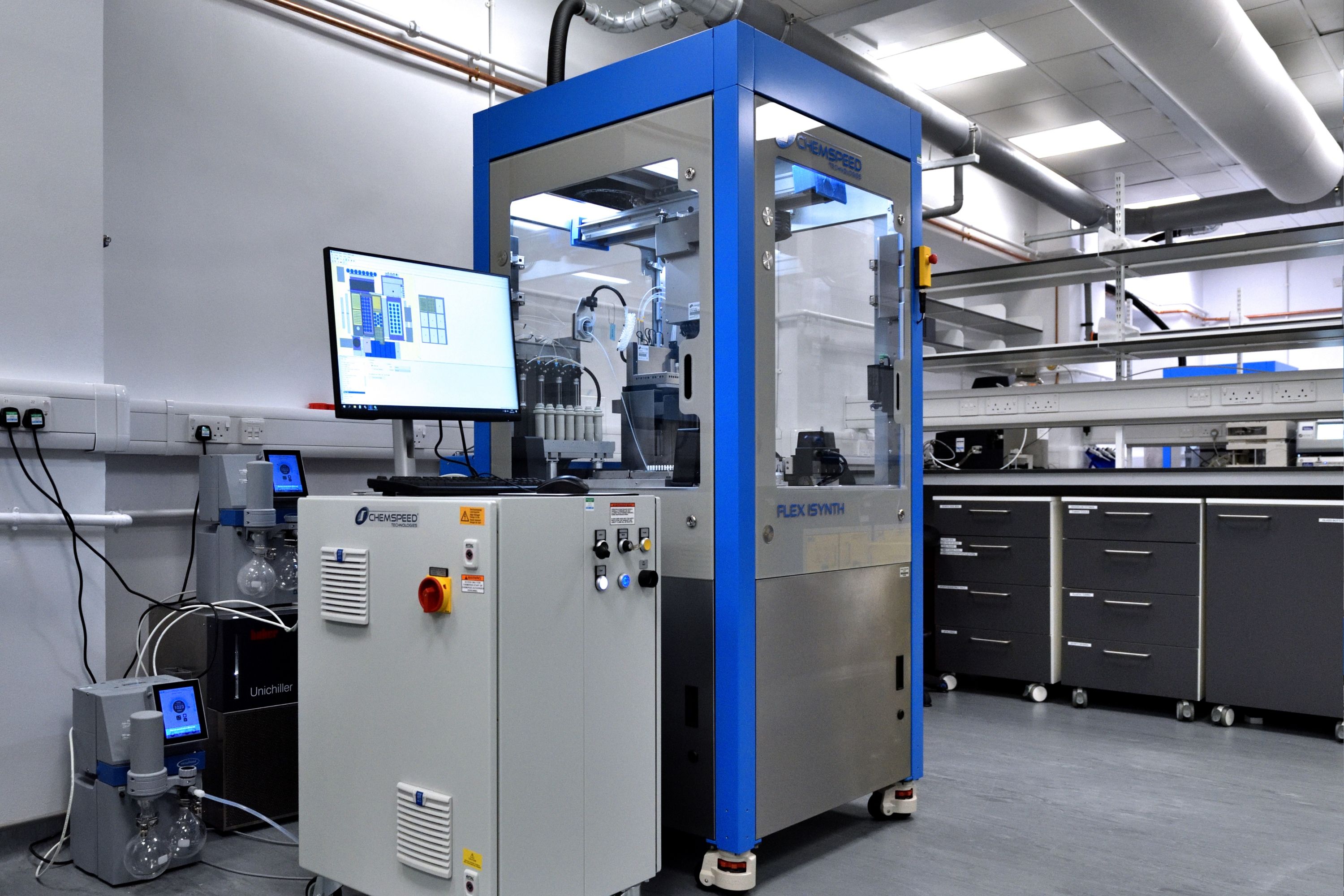 A photograph of a Chemspeed FLEX ISYNTH robotic platform used for automated synthesis