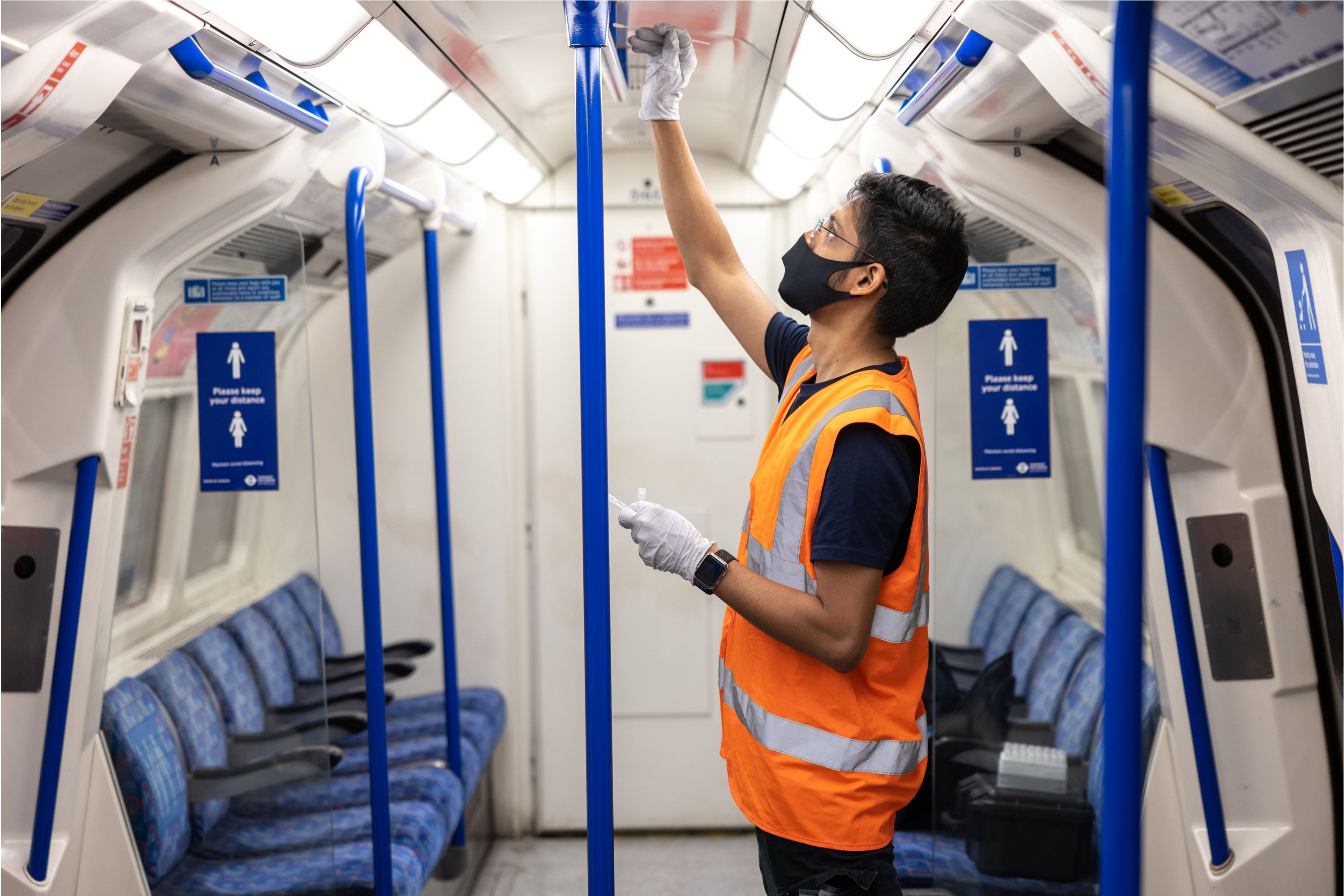 A student swabbing a pole on a tube carriage