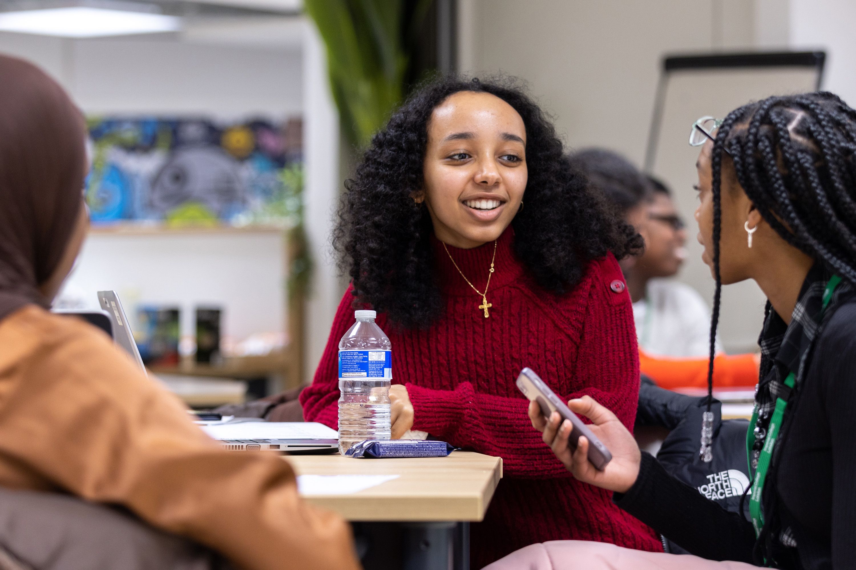 Female students sat at a table chatting