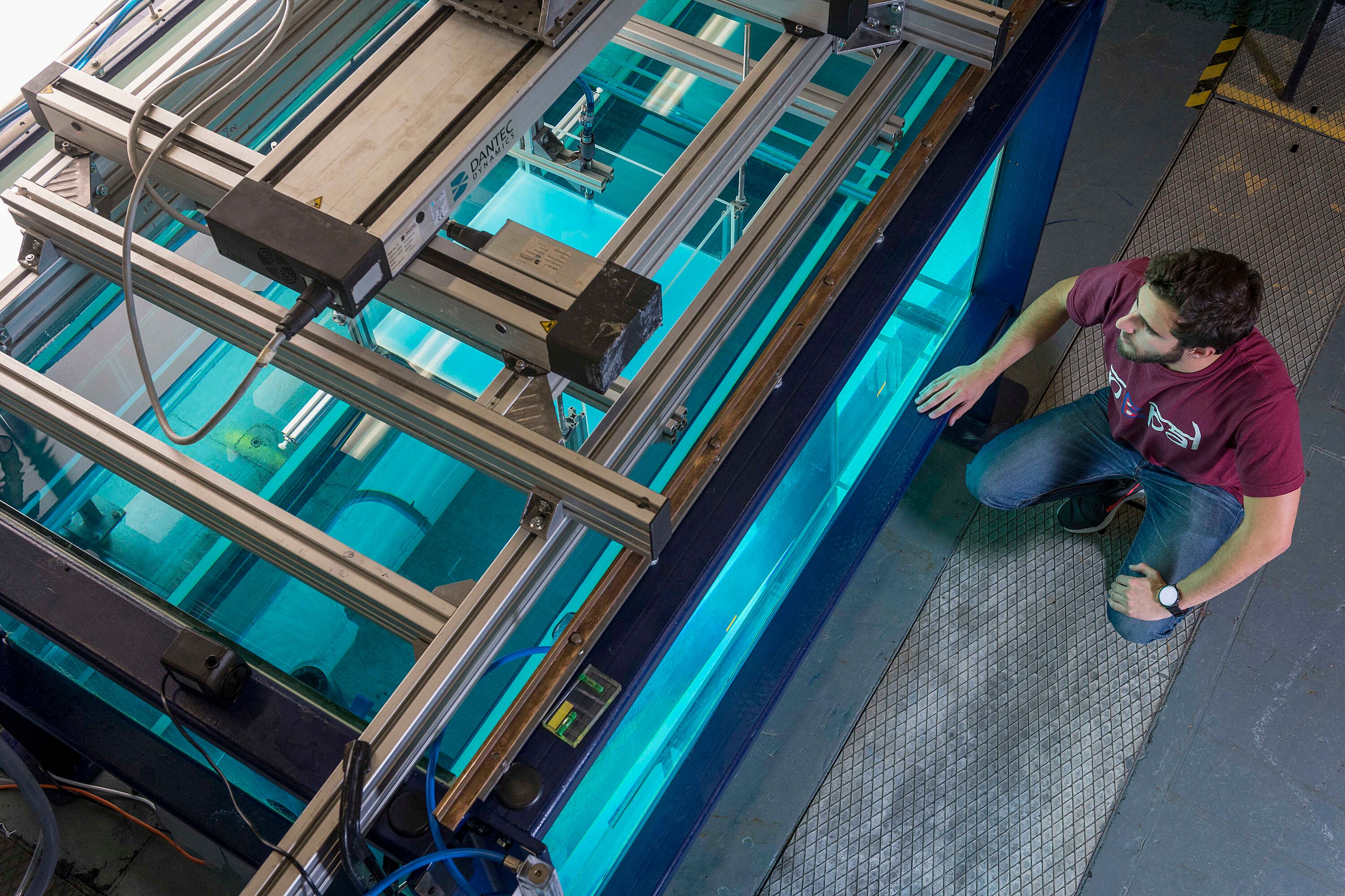 A student inspecting the hydrodynamics laboratory in the department of civil engineering