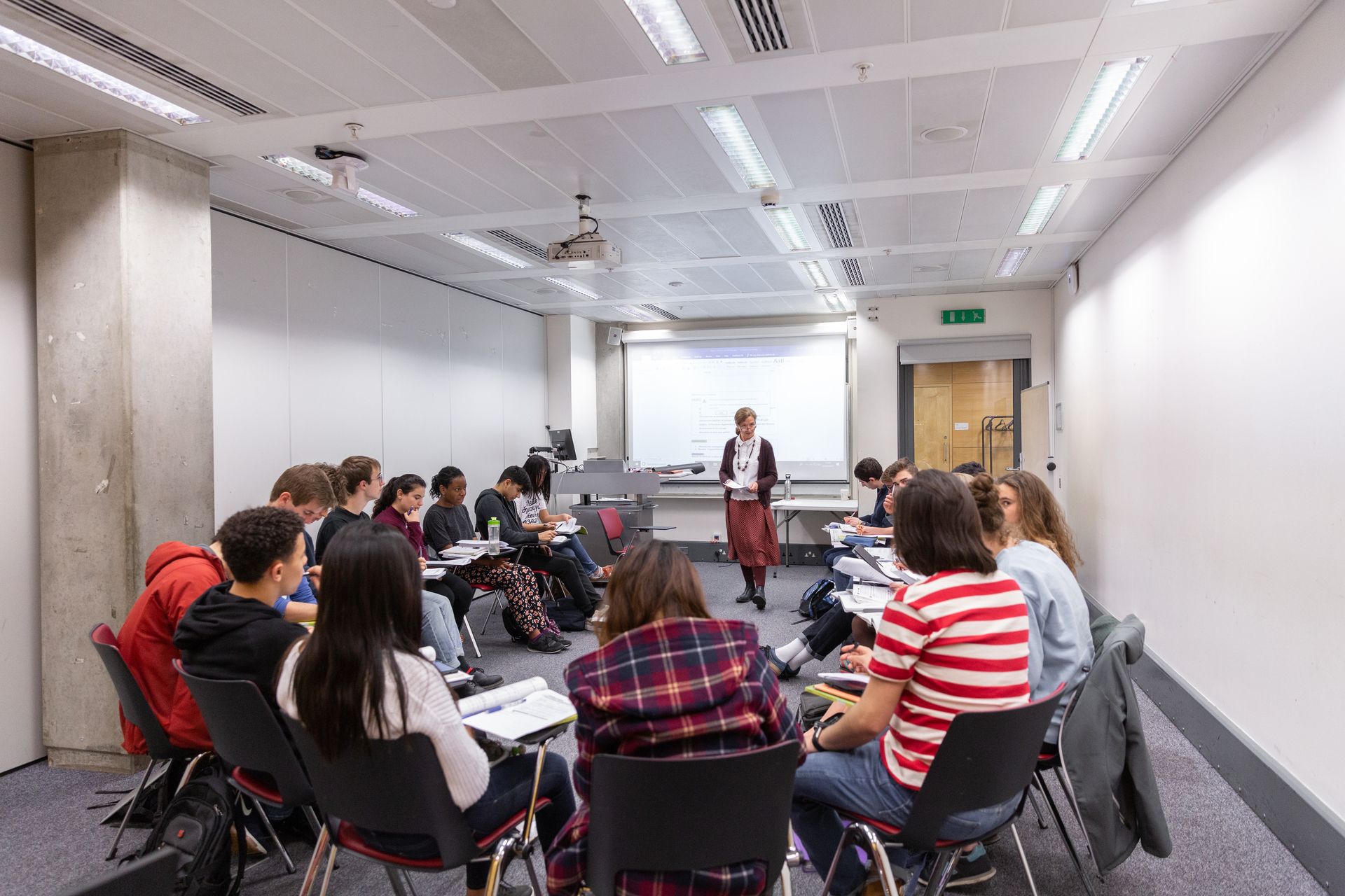 People sat on chairs in a circle in a classroom