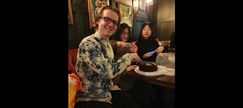 Troy at his viva party with his cake