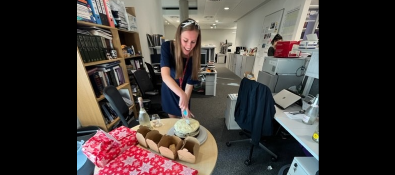 Chloe at her viva with her cake