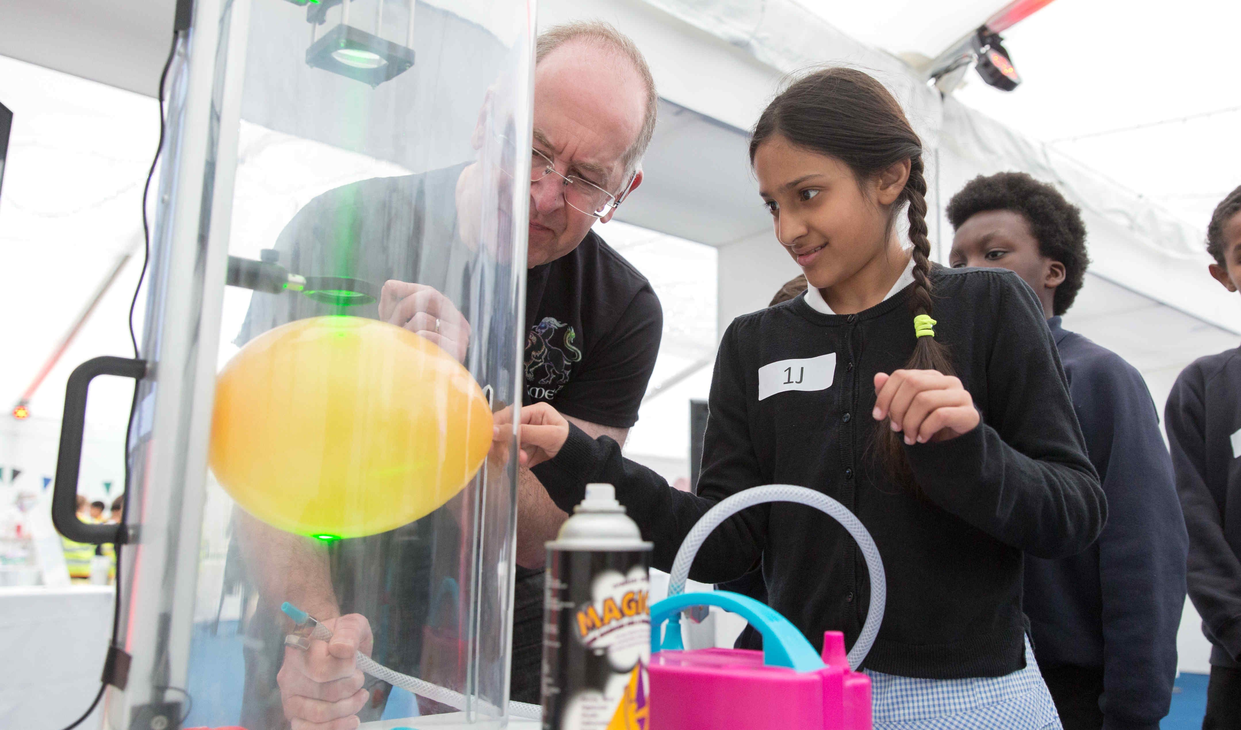 Girl doing balloon experiment in Discover Zone