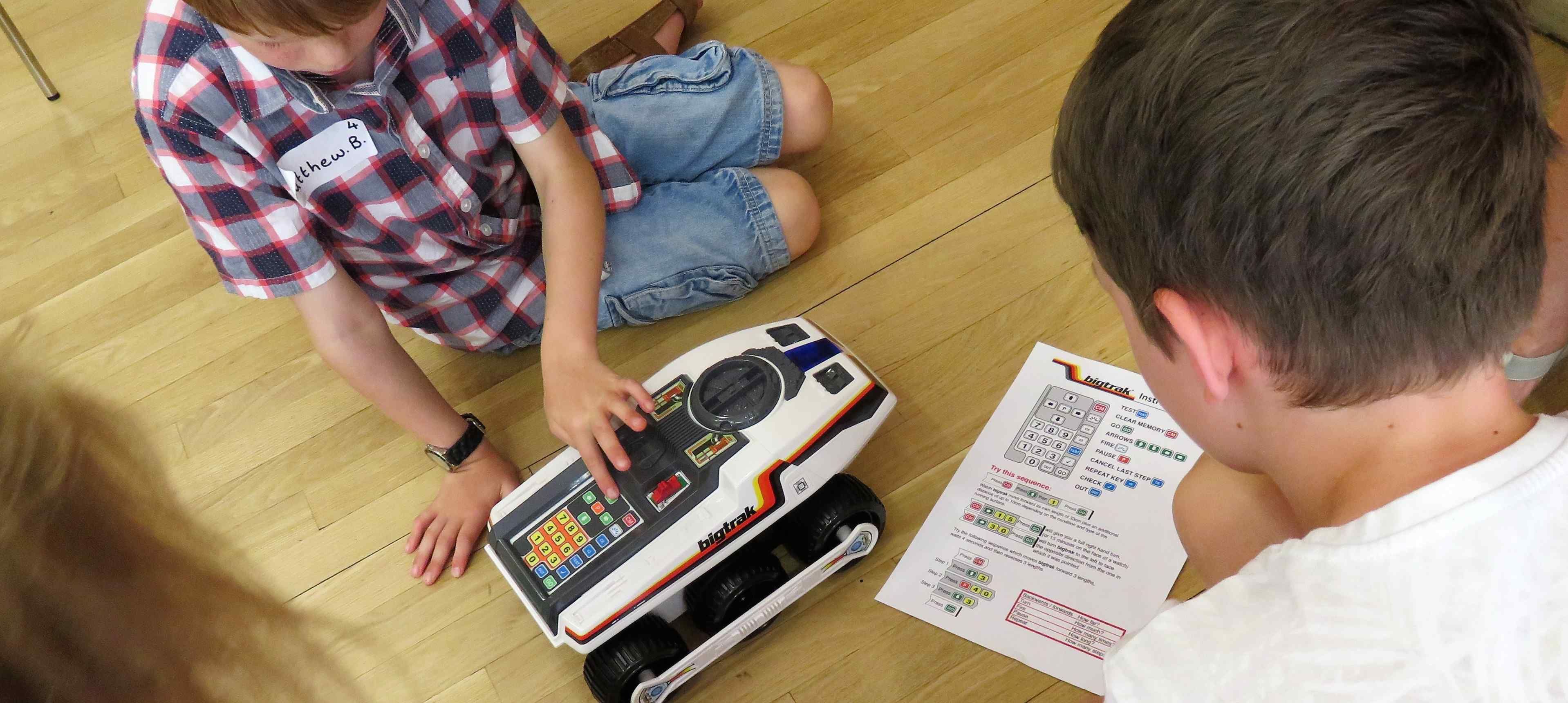 three children carrying out robot task