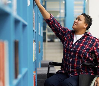 An image of a person in a wheelchair at the library