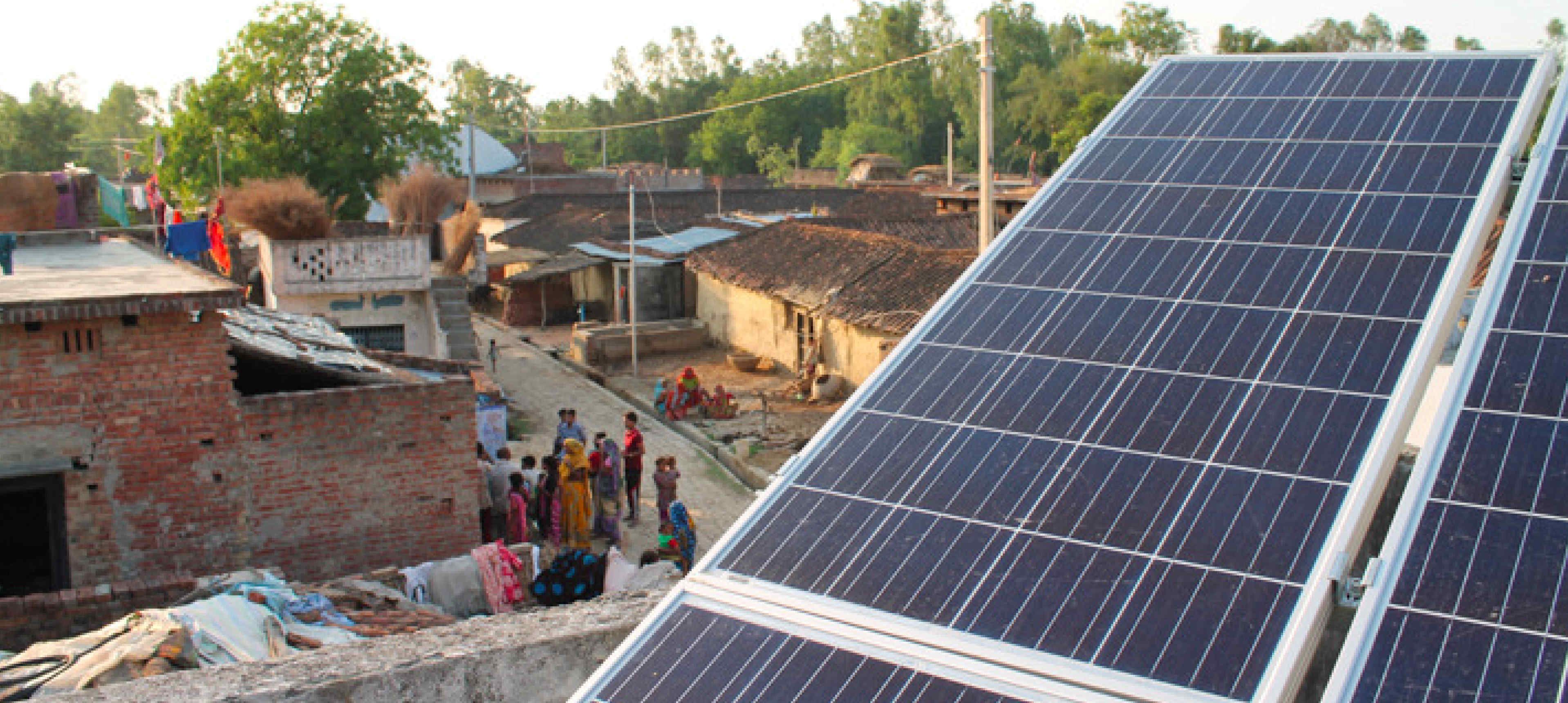 Poor village seen from above with solar panels in the foreground