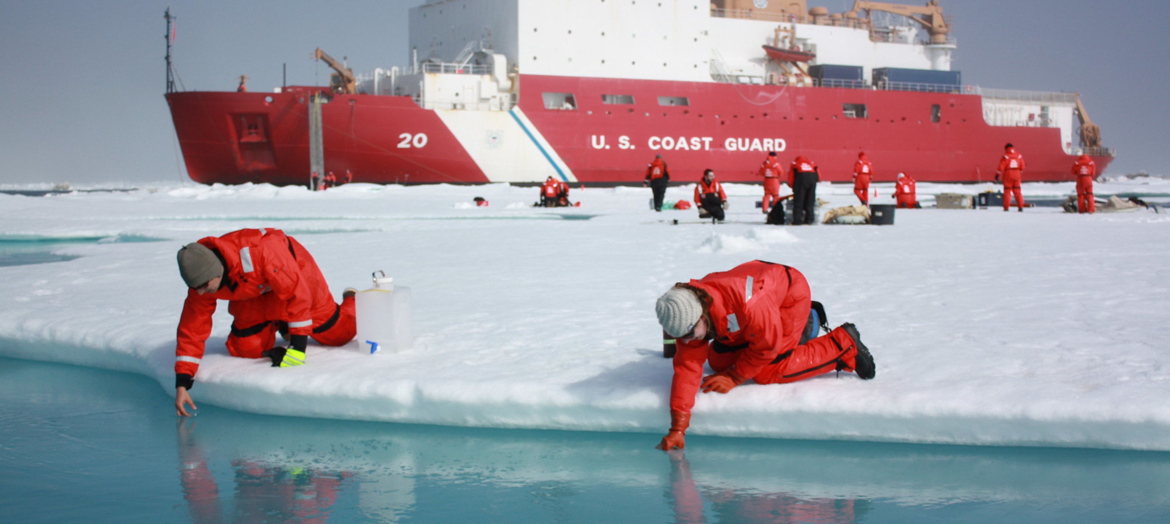 Scientists scooping meltwater from Arctic