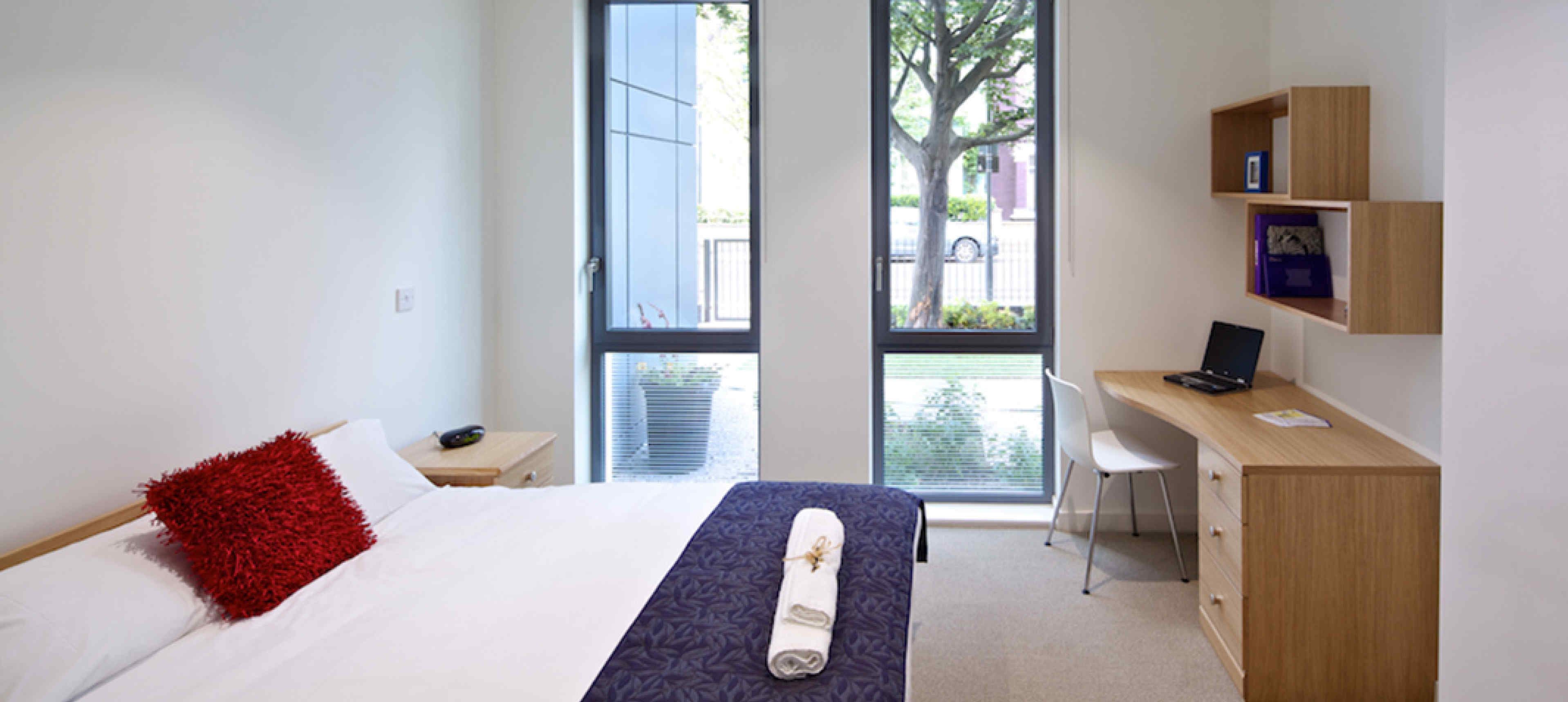 Double bedroom with floor to ceiling windows