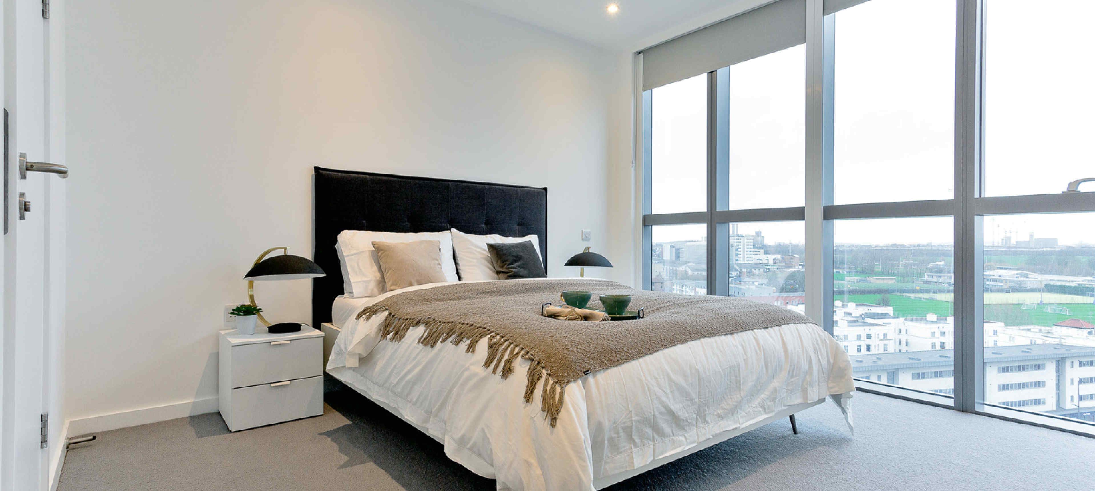 Master bedroom with king bed and floor to ceiling windows