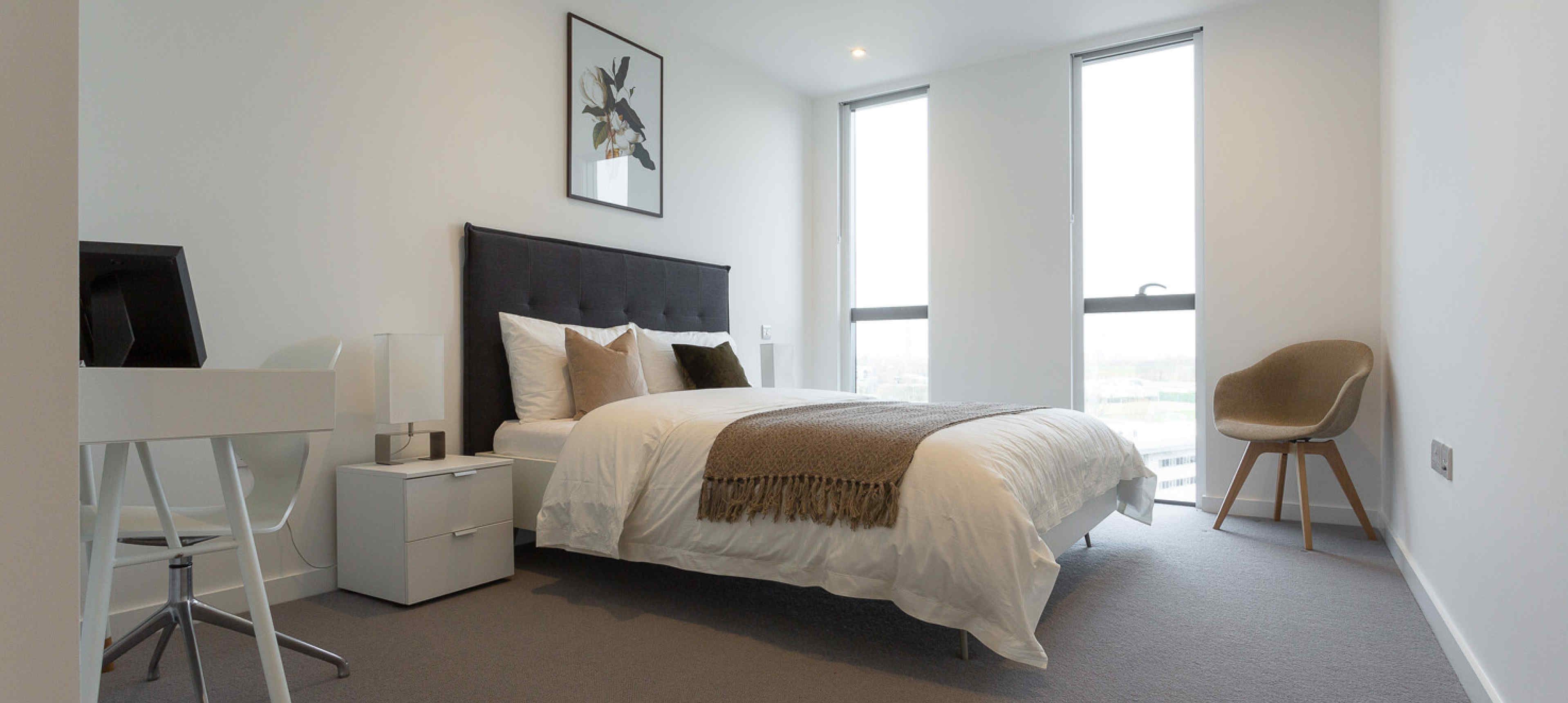 Master bedroom with king bed and full length windows at Eighty Eight Wood Lane