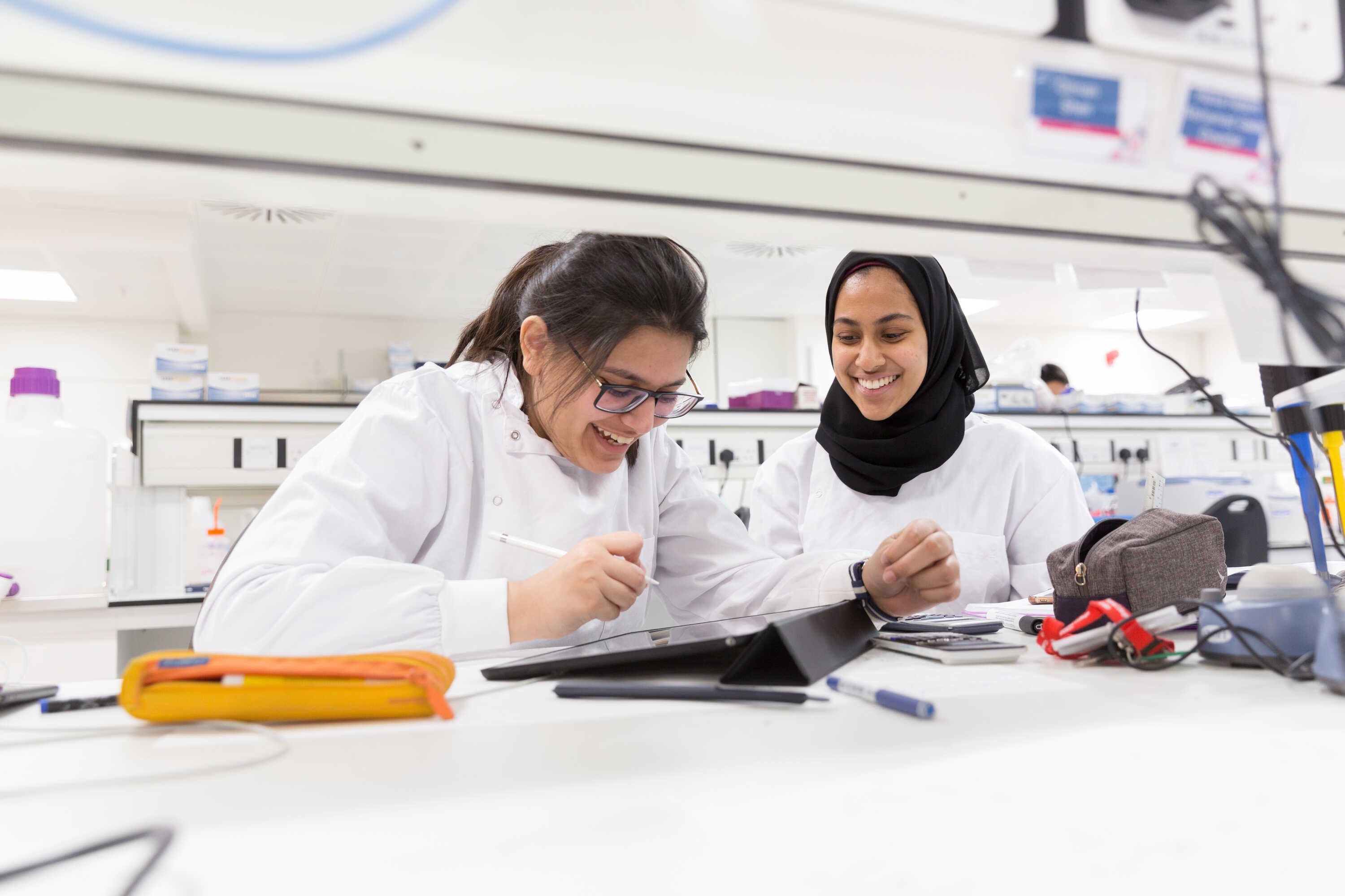 Students smiling working in lab