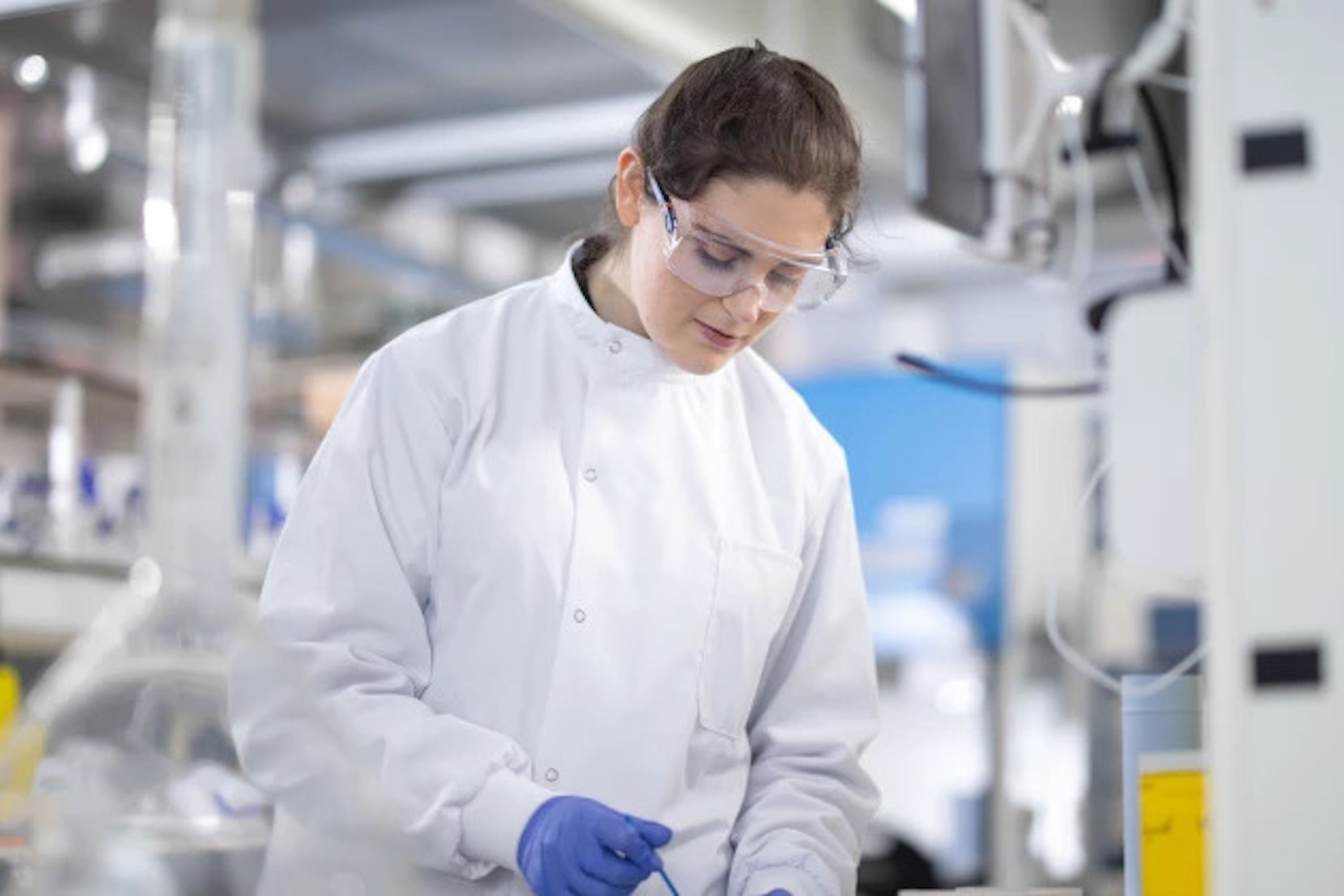 Student in safety equipment in lab