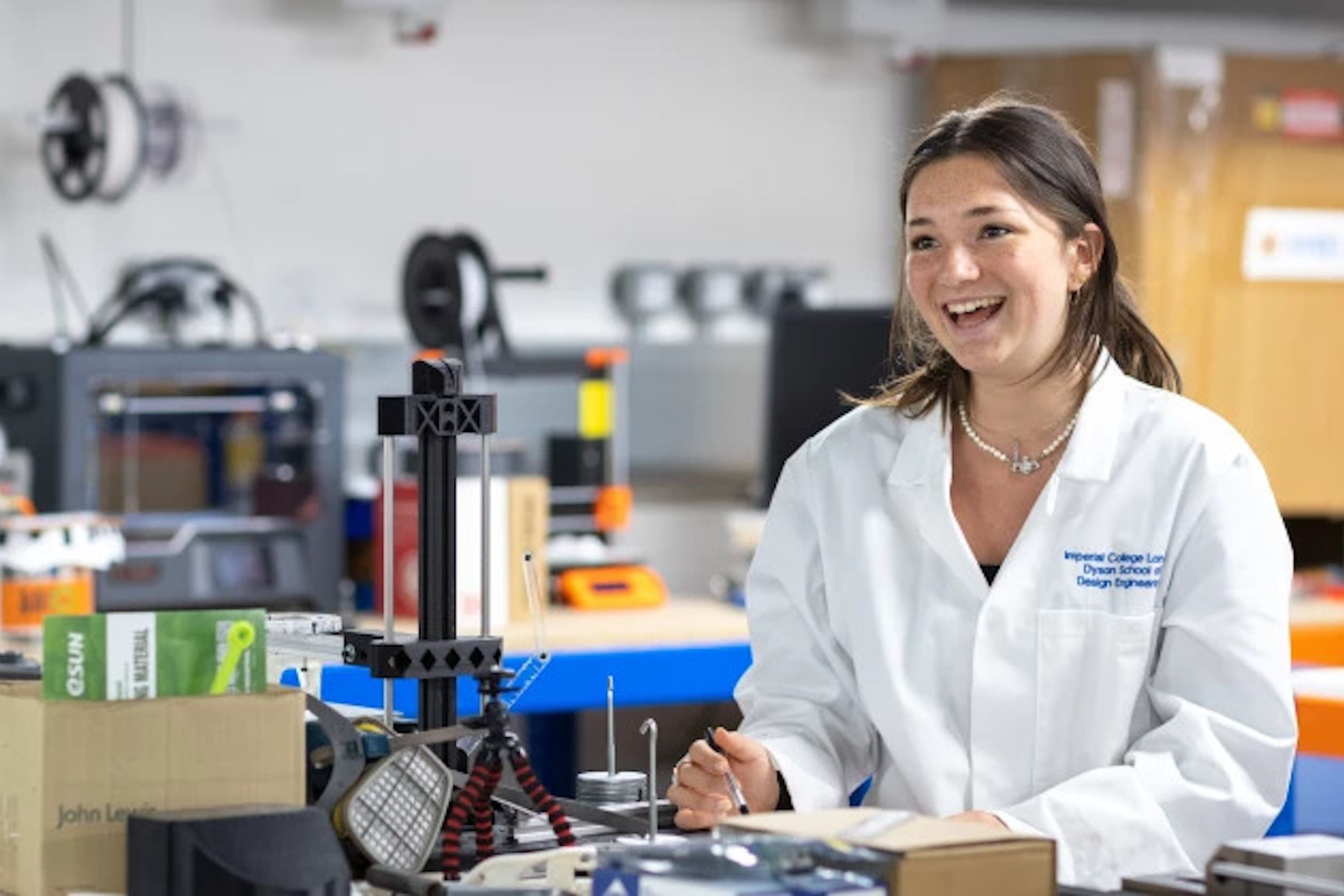 Student smiling with workshop equipment