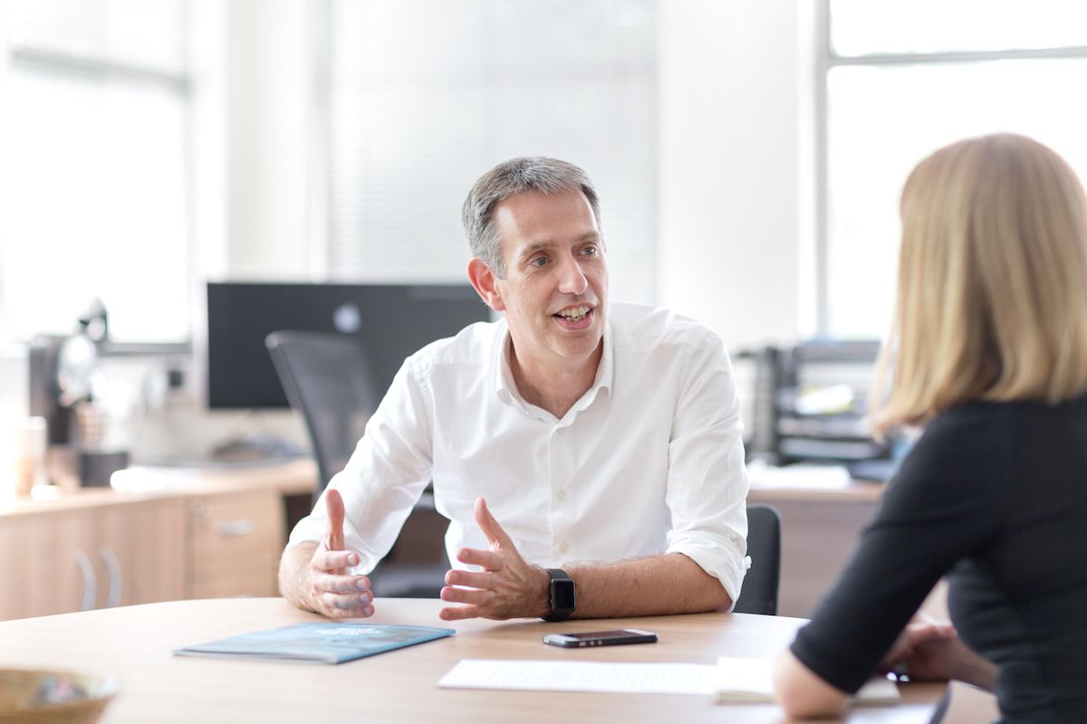 Staff talking together at table