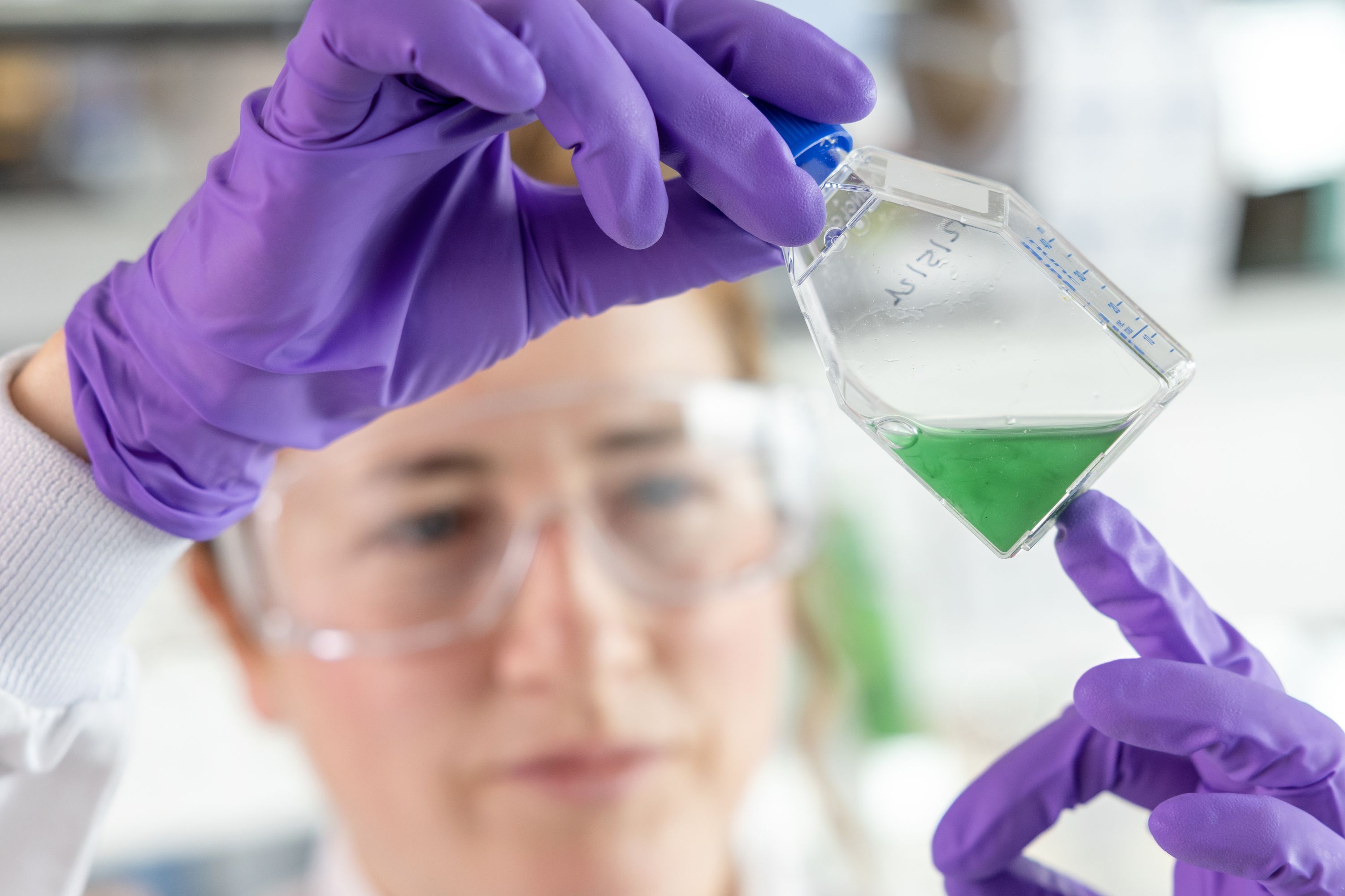 
      A student looking at a vial of liquid