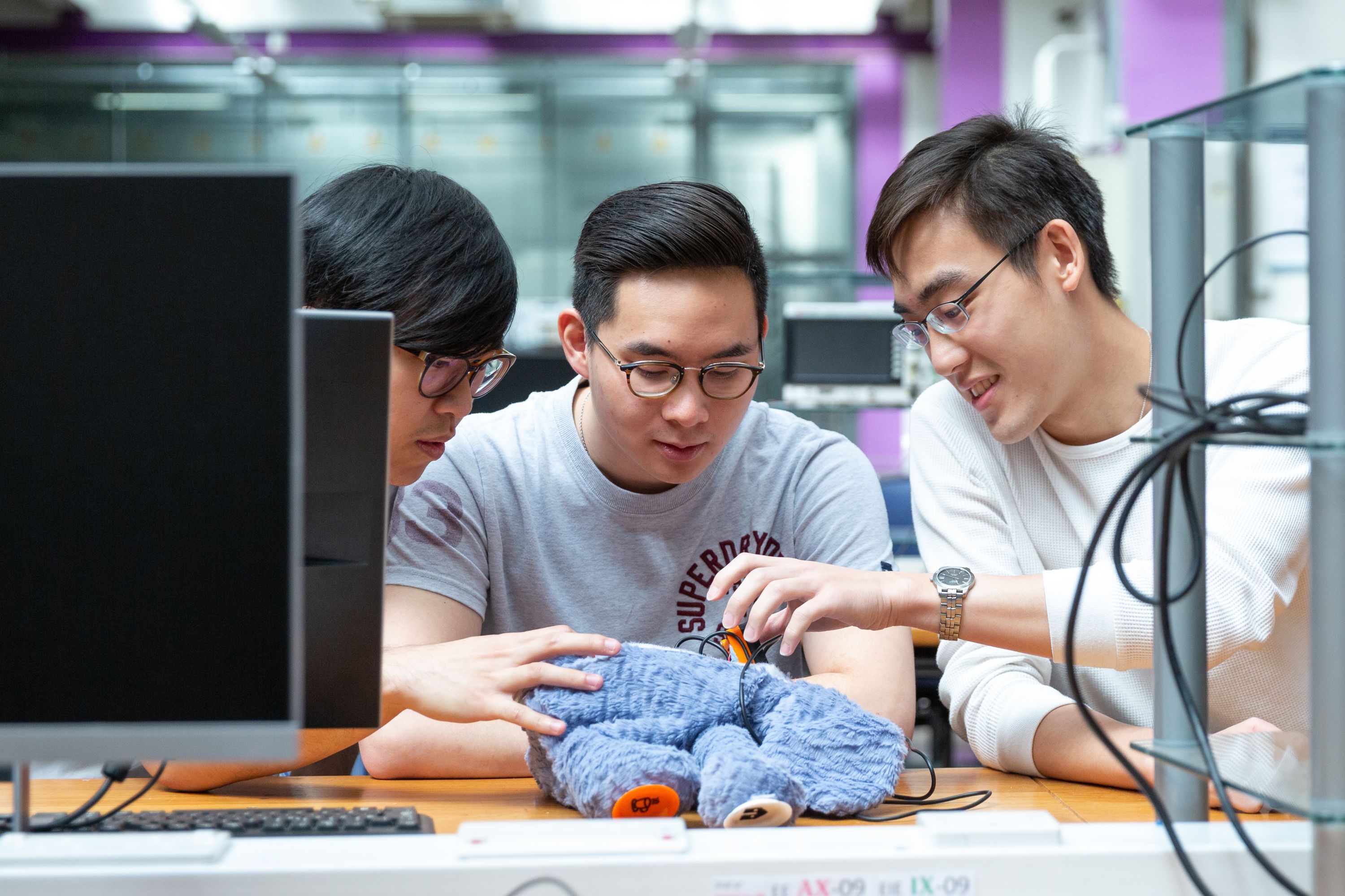 
      Three students working on a project