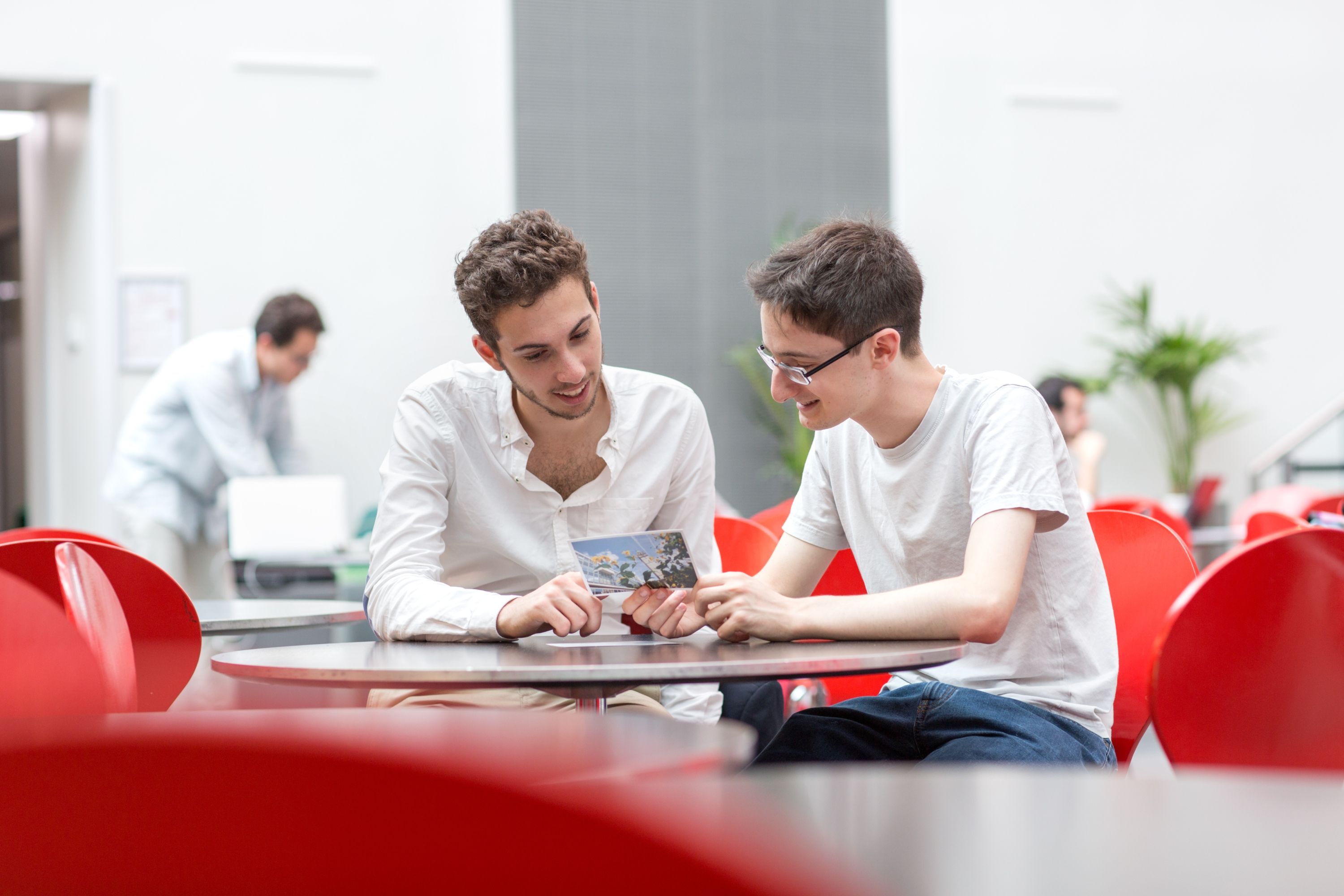 
      Two students sitting at a table