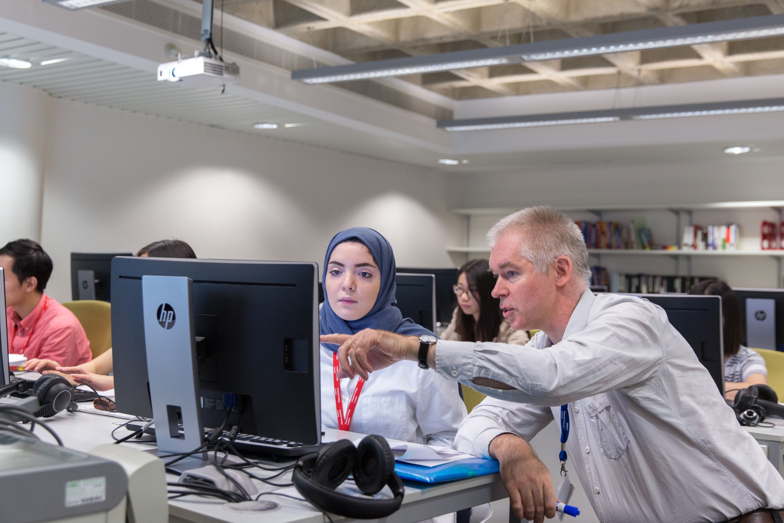 Two people sat at a computer